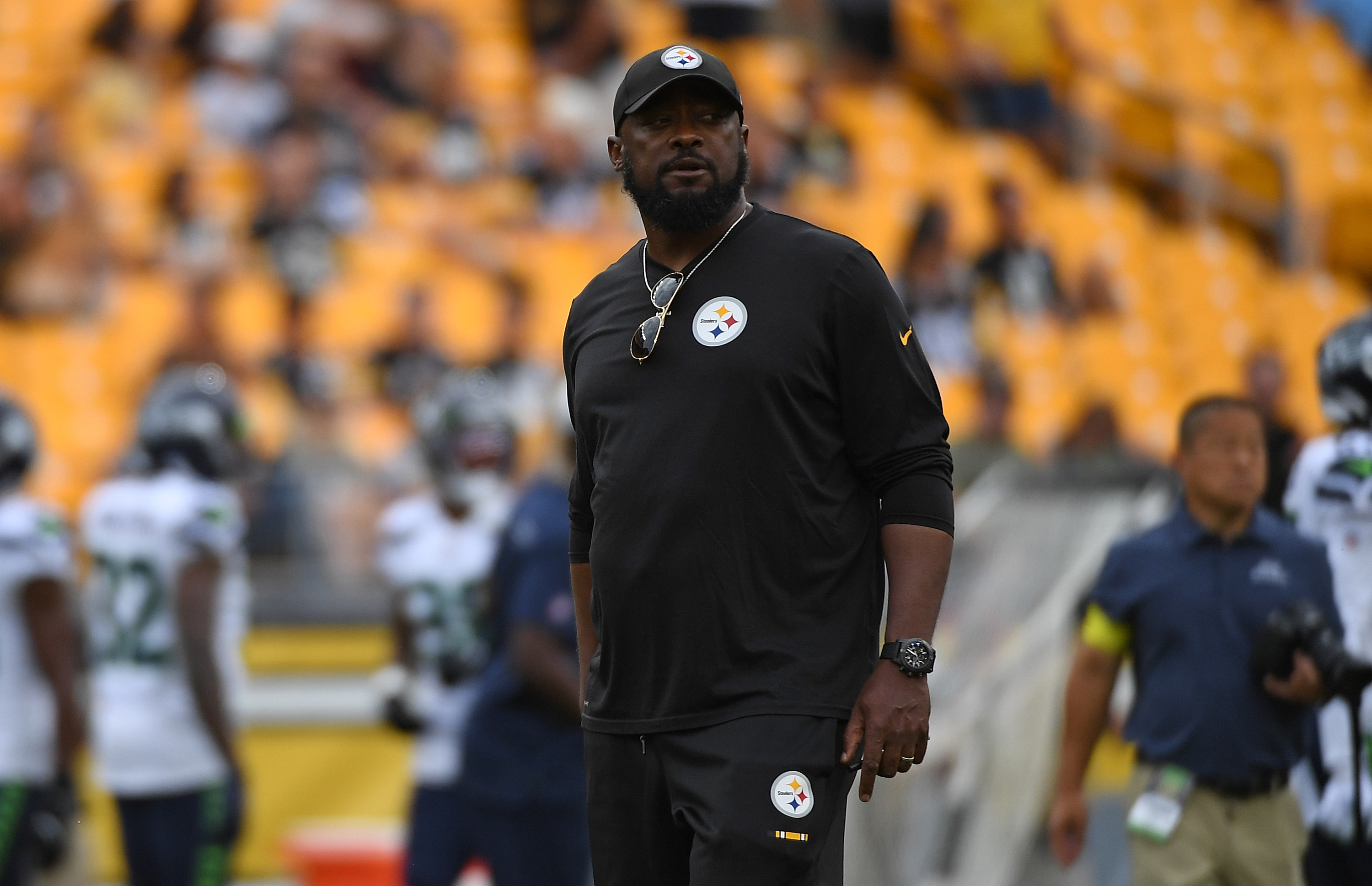 Pittsburgh Steelers head coach Mike Tomlin, center, looks at a