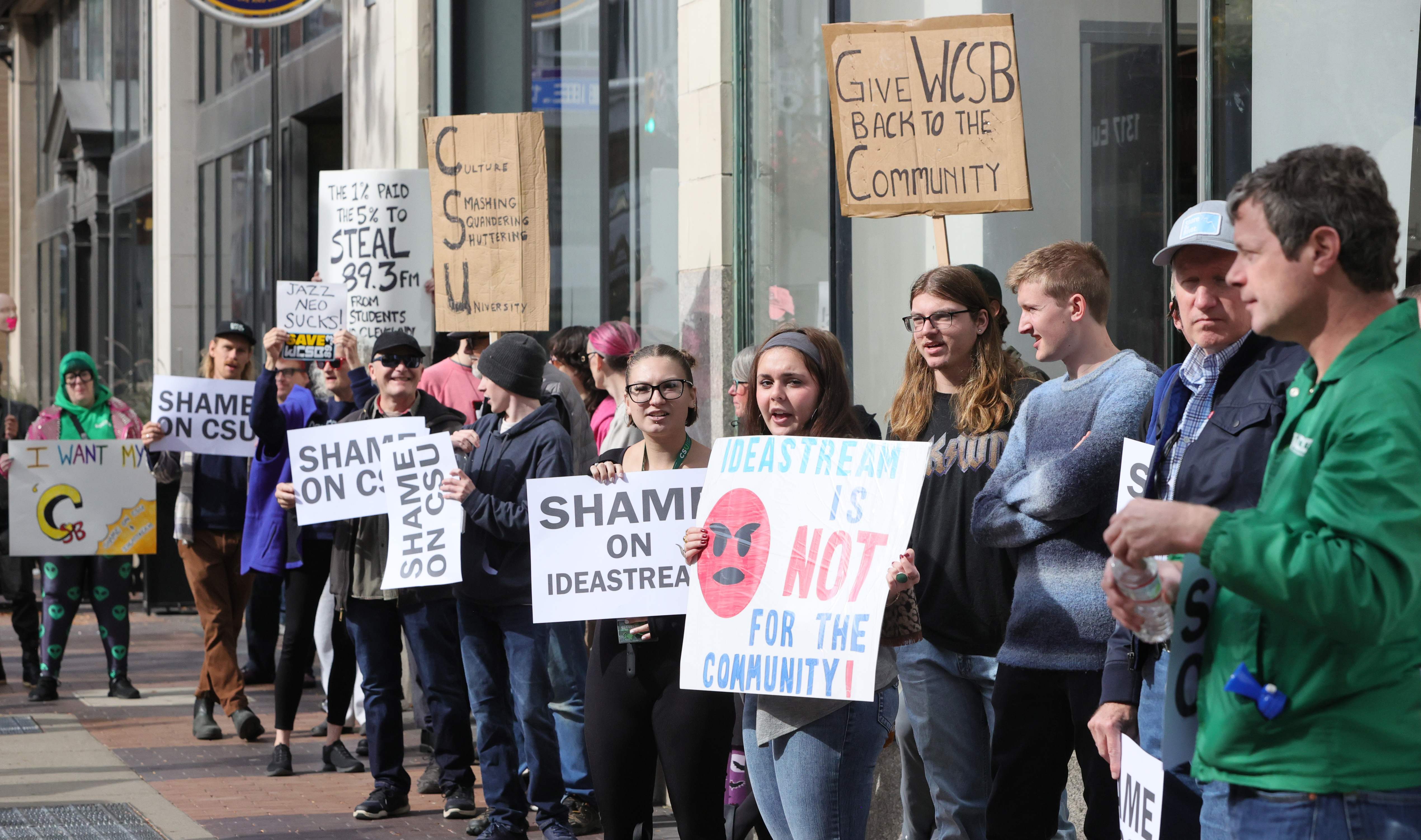 Protestors rally outside Cleveland’s City Club during lunch forum with ...