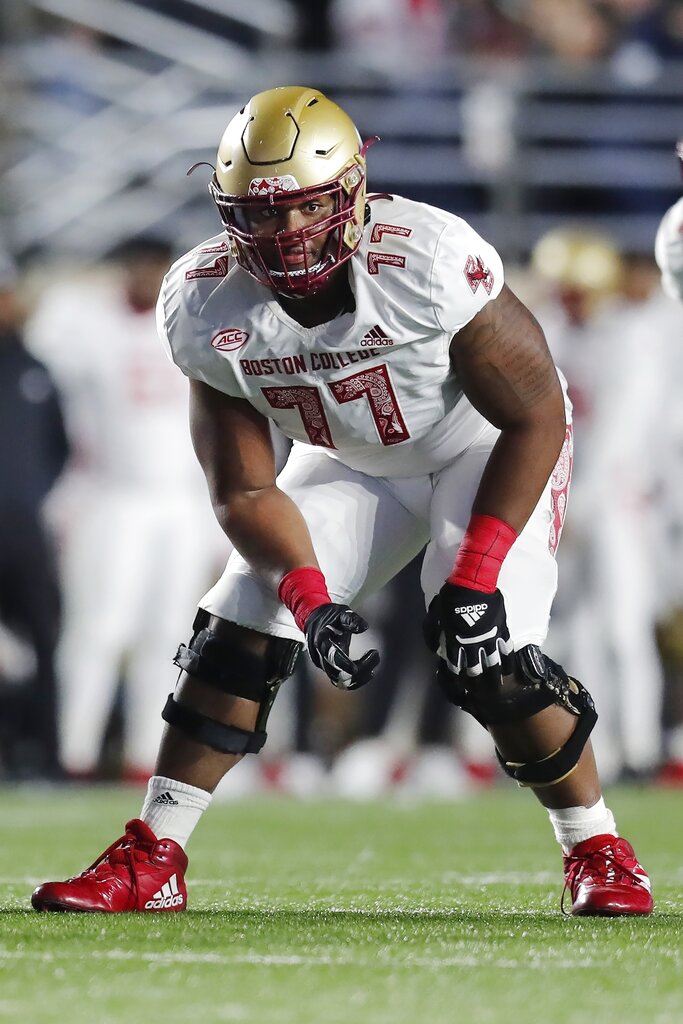 Boston College offensive guard Zion Johnson holds a team jersey