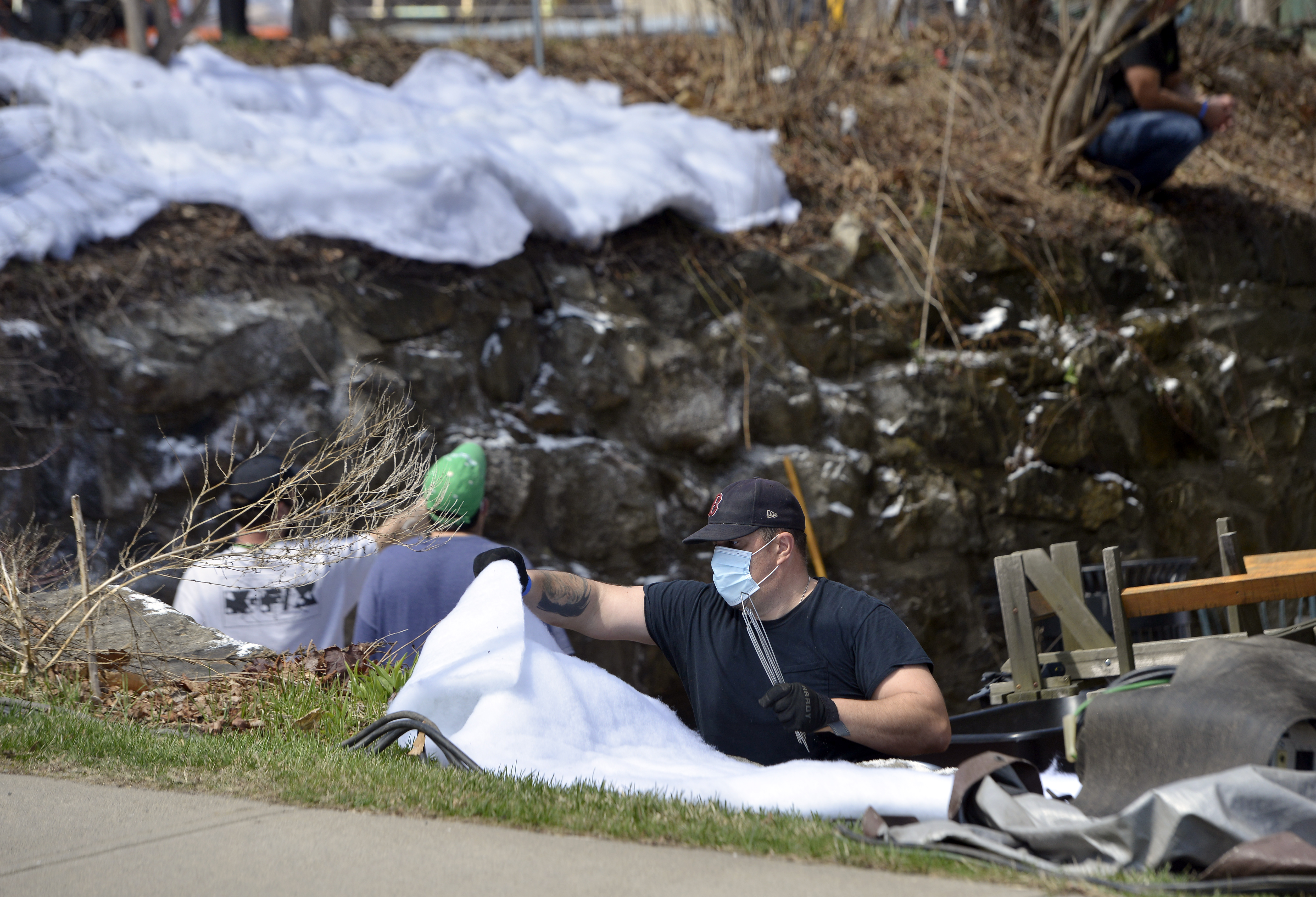 A crew member lays down fake snow behind McCusker's Market in Shelburne Falls for filming a scene of the series Dexter, now being shot in downtown Shelburne Falls.  (Don Treeger / The Republican)  4/7/2021