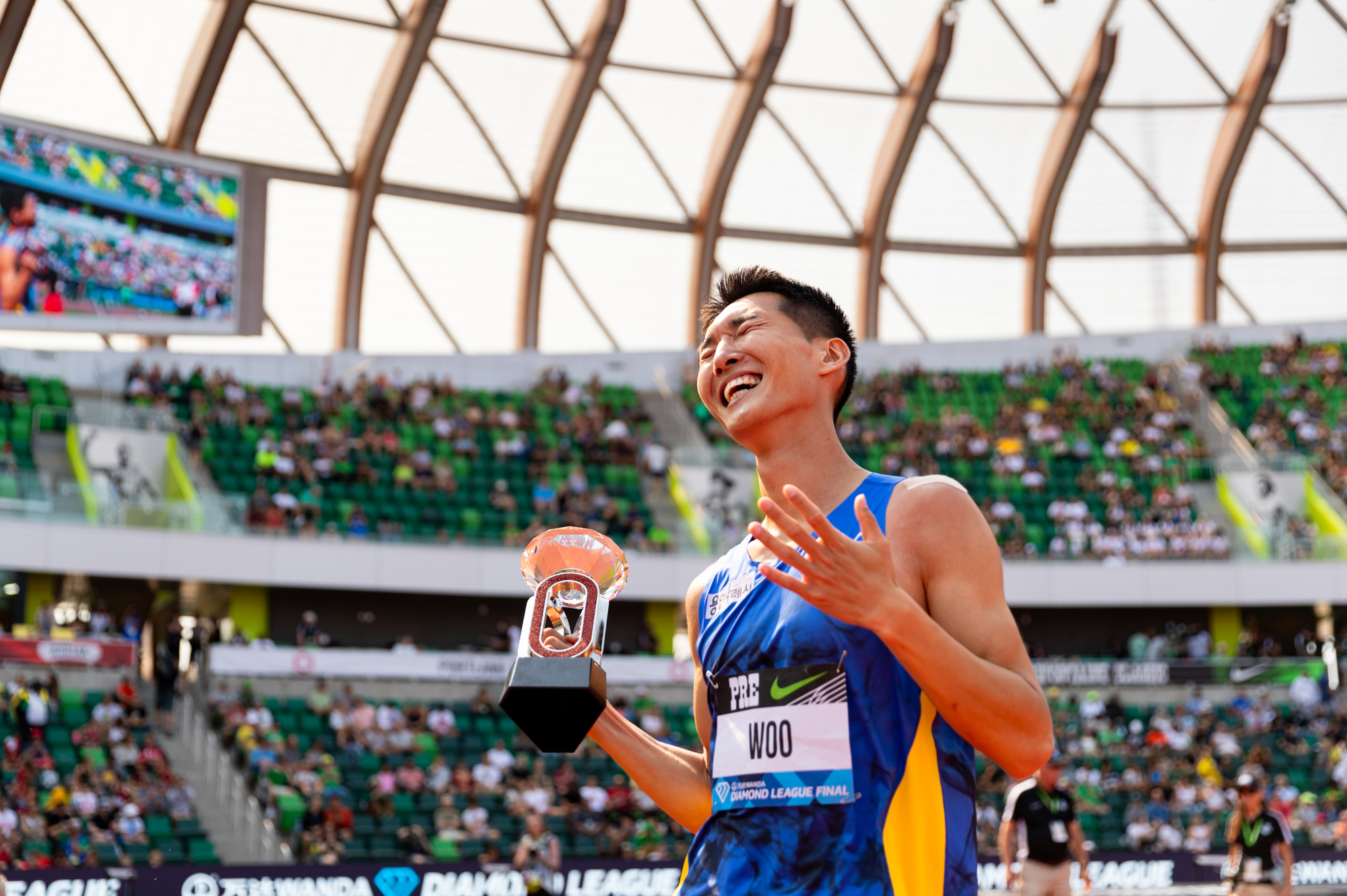 South Korea's Sanghyeok Woo celebrates with the Diamond League trophy after winning the men's high jump at the Prefontaine Classic track and field meet on Saturday, Sept. 16, 2023, at Hayward Field in Eugene.