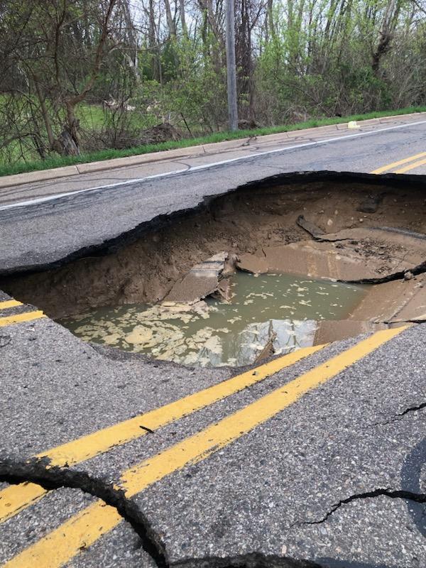 Giant sinkhole collapses road, damaging car in Southwest Michigan