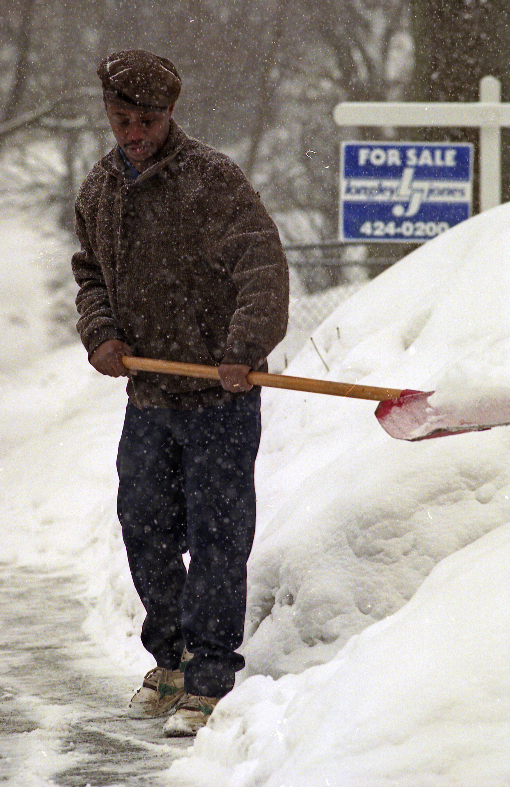 William Raeford, of 2406 East Genesee Street, Syracuse, shovels out the front of his home during the Blizzard of 1993.