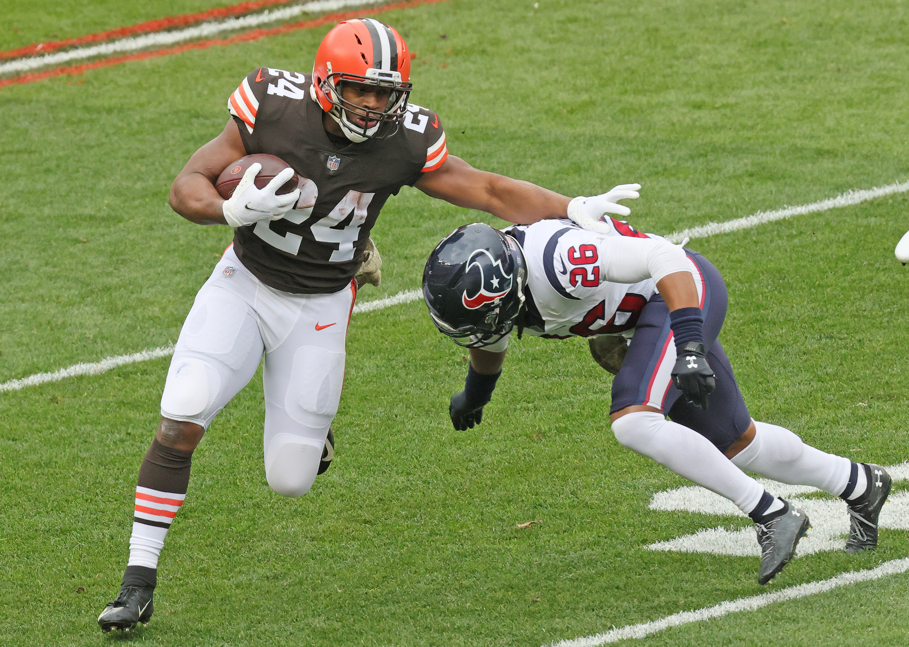 Cleveland Browns Nick Chubb Unsigned Brown Jersey Carrying Ball Photograph