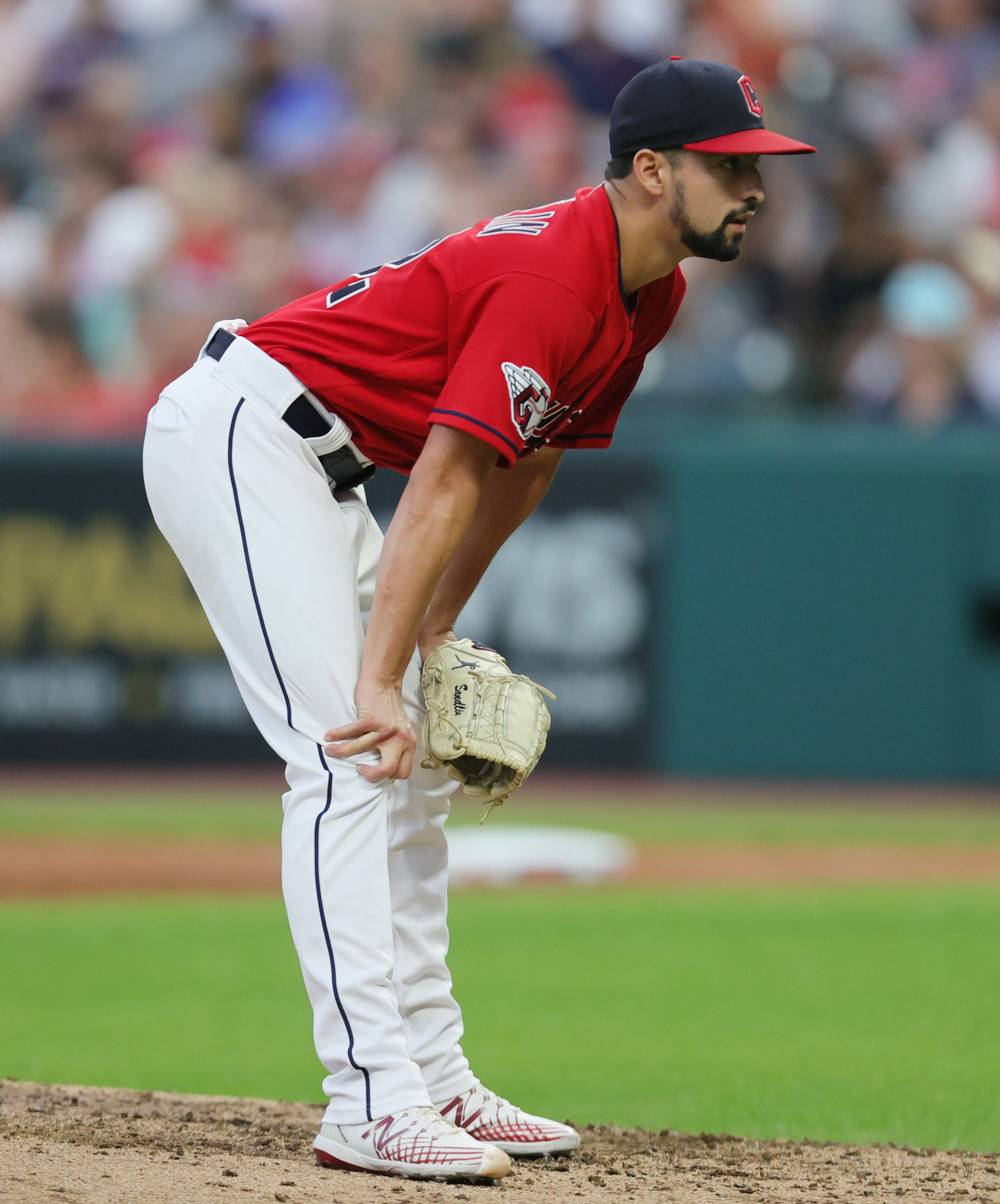 Cleveland Guardians relief pitcher Nick Sandlin bends holding his knees after giving up a solo homer off the bat of Tampa Bay Rays center fielder Jose Siri in the sixth inning, September 2, 2023, at Progressive Field.