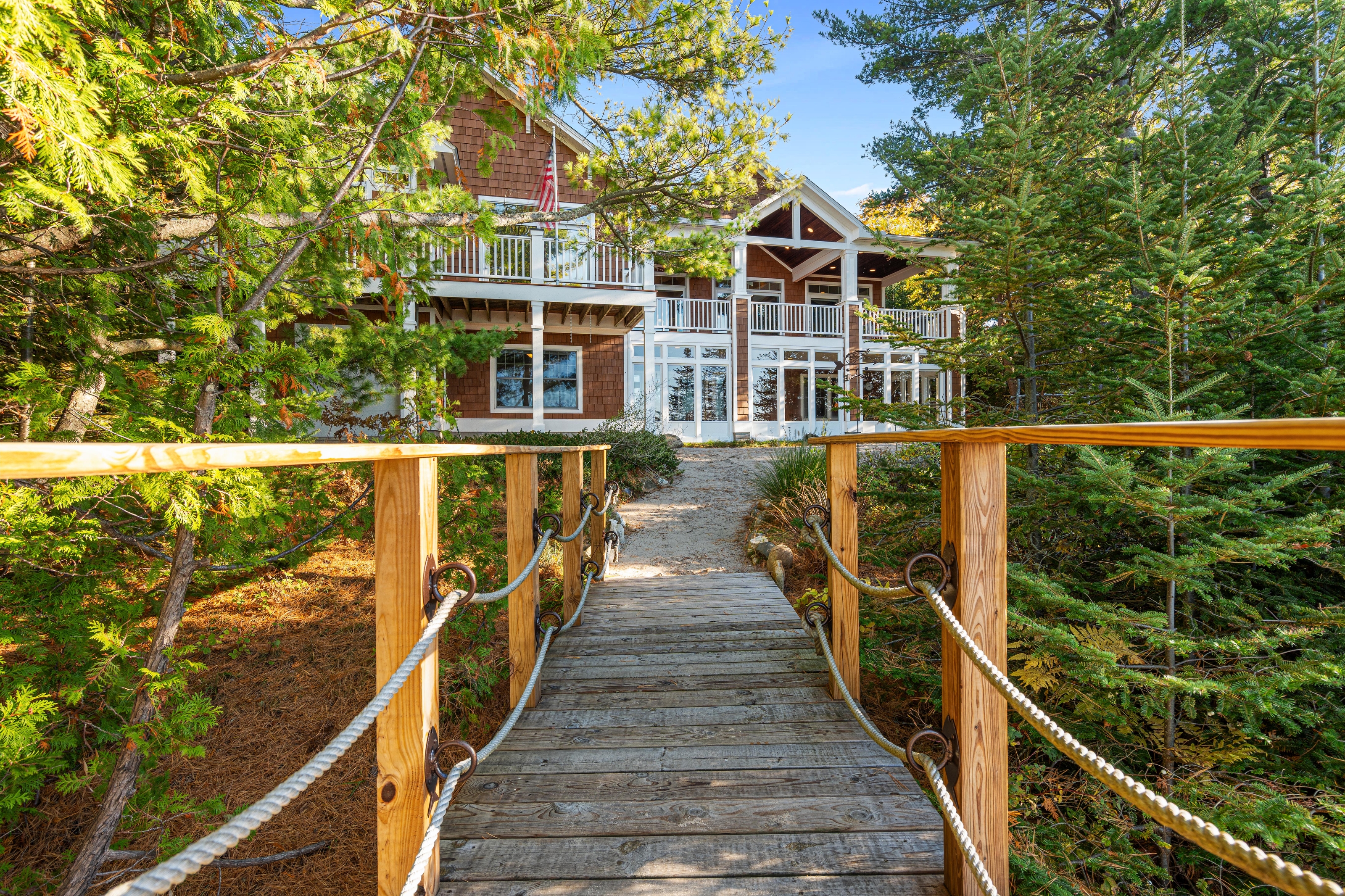 Exterior photographs of 4093 Lake Shore Drive in Charlevoix, this gem is listed at $2,099,900 through Berkshire Hathaway HomeServices Michigan Real Estate – Traverse City and The Crane Group with associate broker Johnny Crane and his brother, co-listing agent Matt Crane.