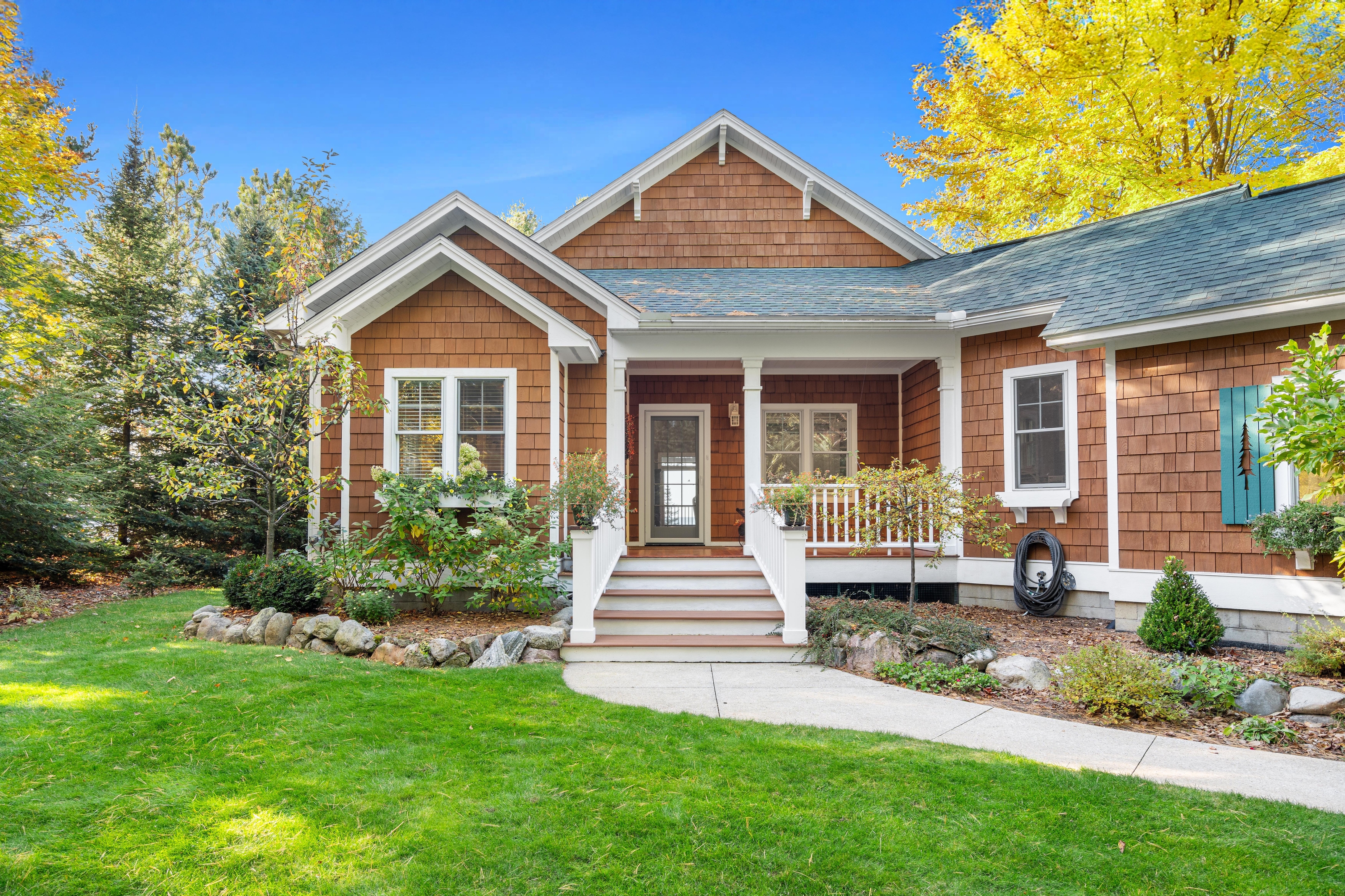 Exterior photographs of 4093 Lake Shore Drive in Charlevoix, this gem is listed at $2,099,900 through Berkshire Hathaway HomeServices Michigan Real Estate – Traverse City and The Crane Group with associate broker Johnny Crane and his brother, co-listing agent Matt Crane.