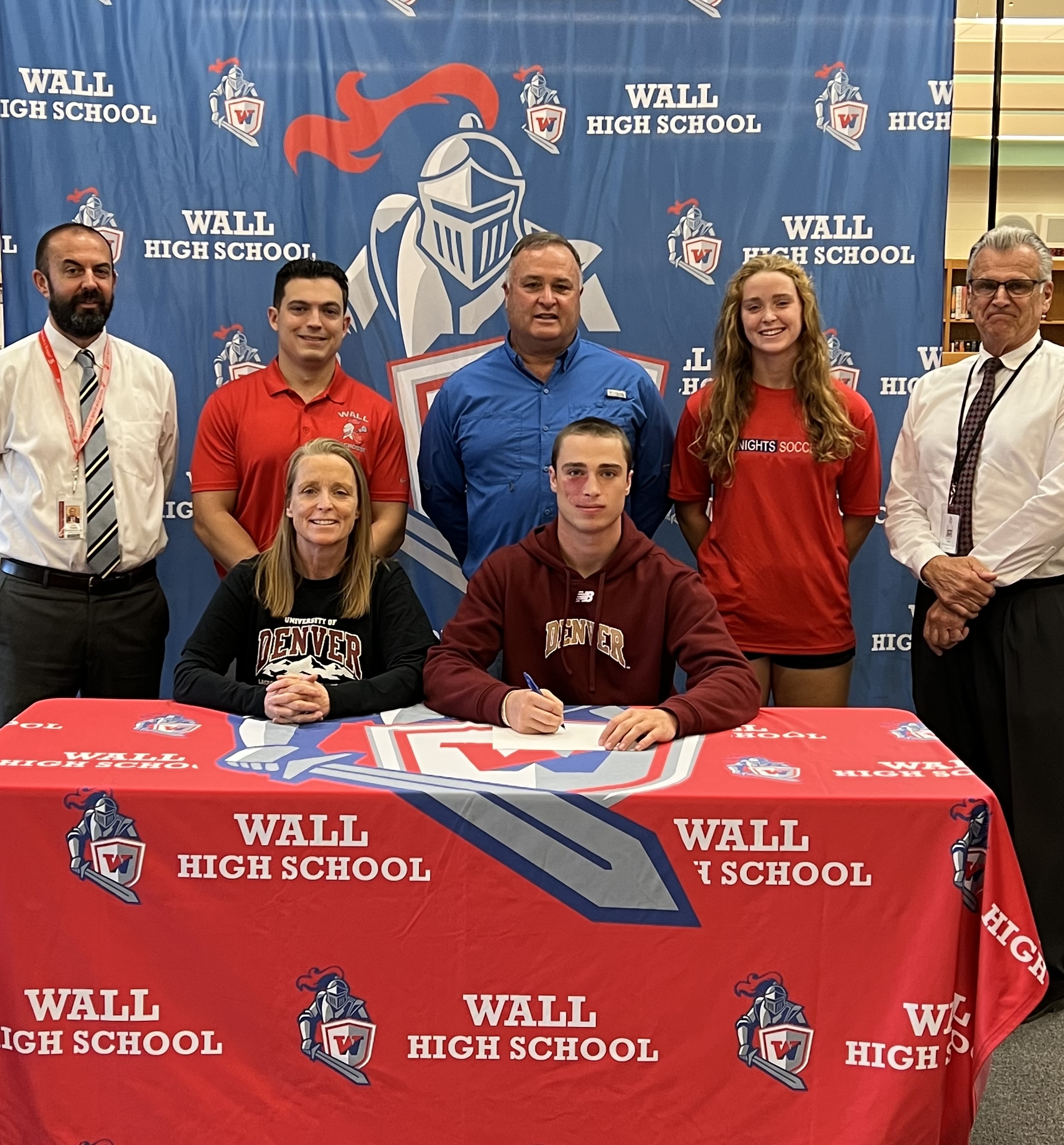 Wall's Billy Carr signs his NLI to play lacrosse at Denver; Bottom sitting, right-left Billy Carr & Mom; Standing left to right, Kevin Davis, Assistant Principal, Wall lax coach Victor Rivera, Dad, Sister, Wall HS Principal Dr. Pete Riggi