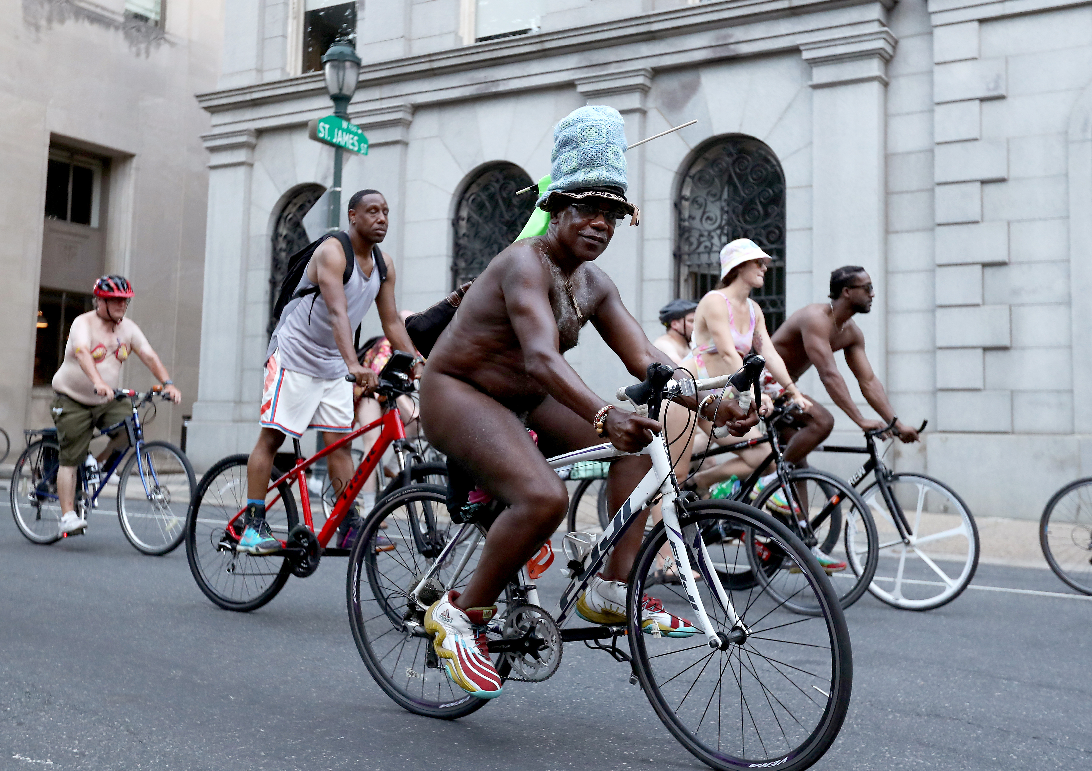 People ride bikes around Washington Square in Philadelphia during the Philly Naked Bike Ride, Saturday, Aug. 27, 2022.