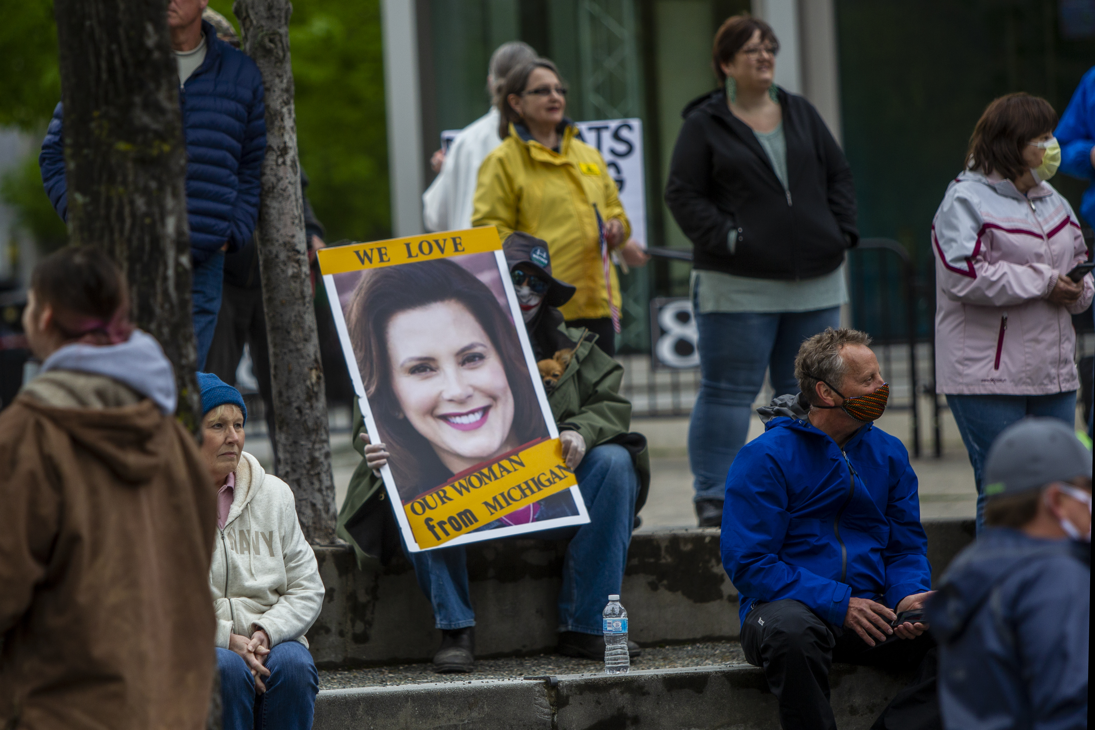A counter-protester watches the "American Patriot Rally-Sheriffs speak out" event at Rosa Parks Circle in downtown Grand Rapids on Monday, May 18, 2020. The crowd is protesting against Gov. Gretchen Whitmer's stay-at-home order. (Cory Morse | MLive.com)