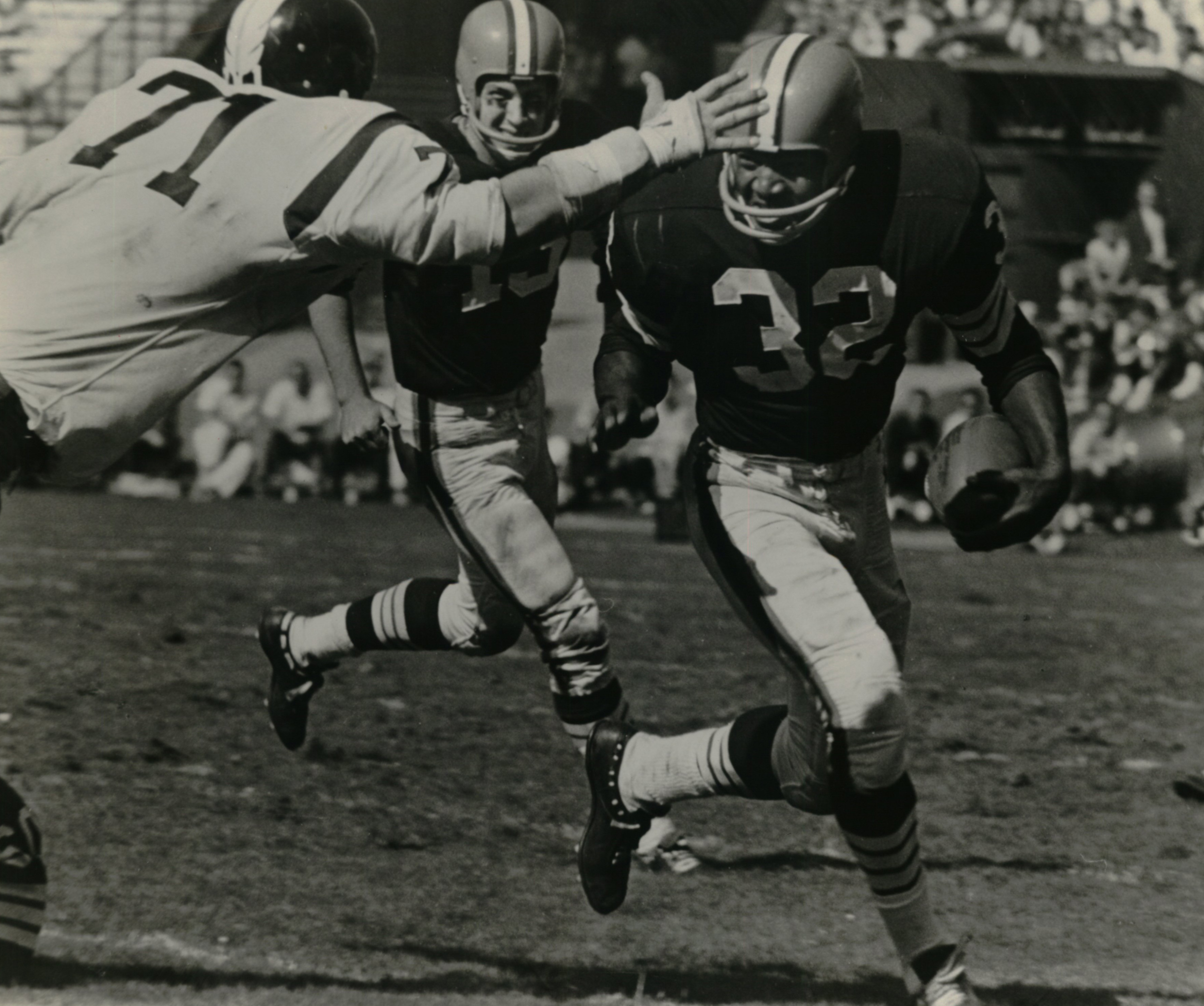 1963 against the Washington Redskins.  Quarterback Frank Ryan smiles as No. 71 of the Redskins is about to get stiff-armed.  Play resulted in first down.  Malcolm W. Emmons.  Jim Brown - Emmons  vs. Washignton, 13 - Frank Ryan.