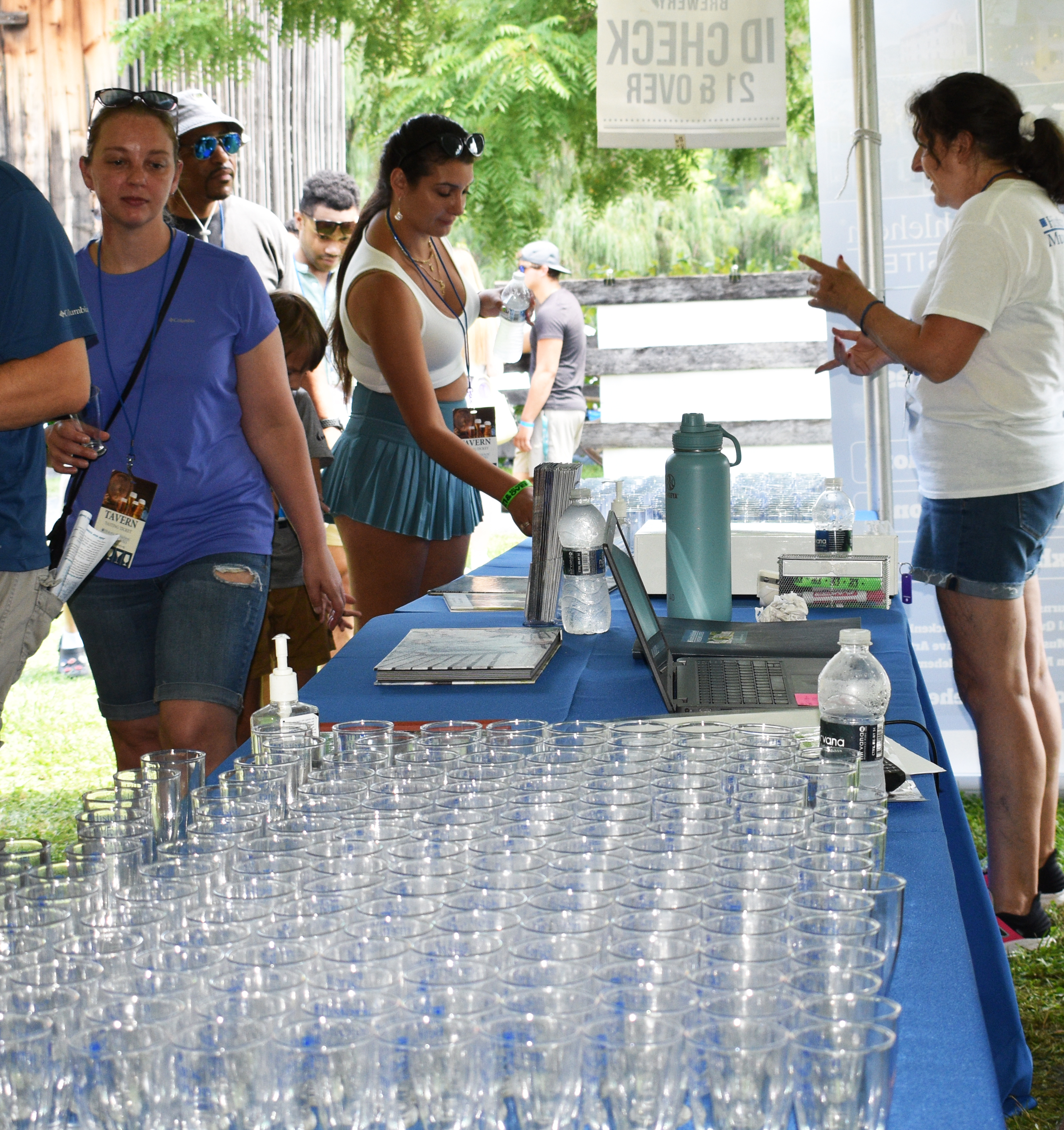 Tasting glasses are arrayed as IDs are checked at the Blueberry Tavern as Historic Bethlehem Museums & Sites hosts the first of two days of its Blueberry Festival & Market To Go on Saturday, July 13, 2024, at Burnside Plantation.