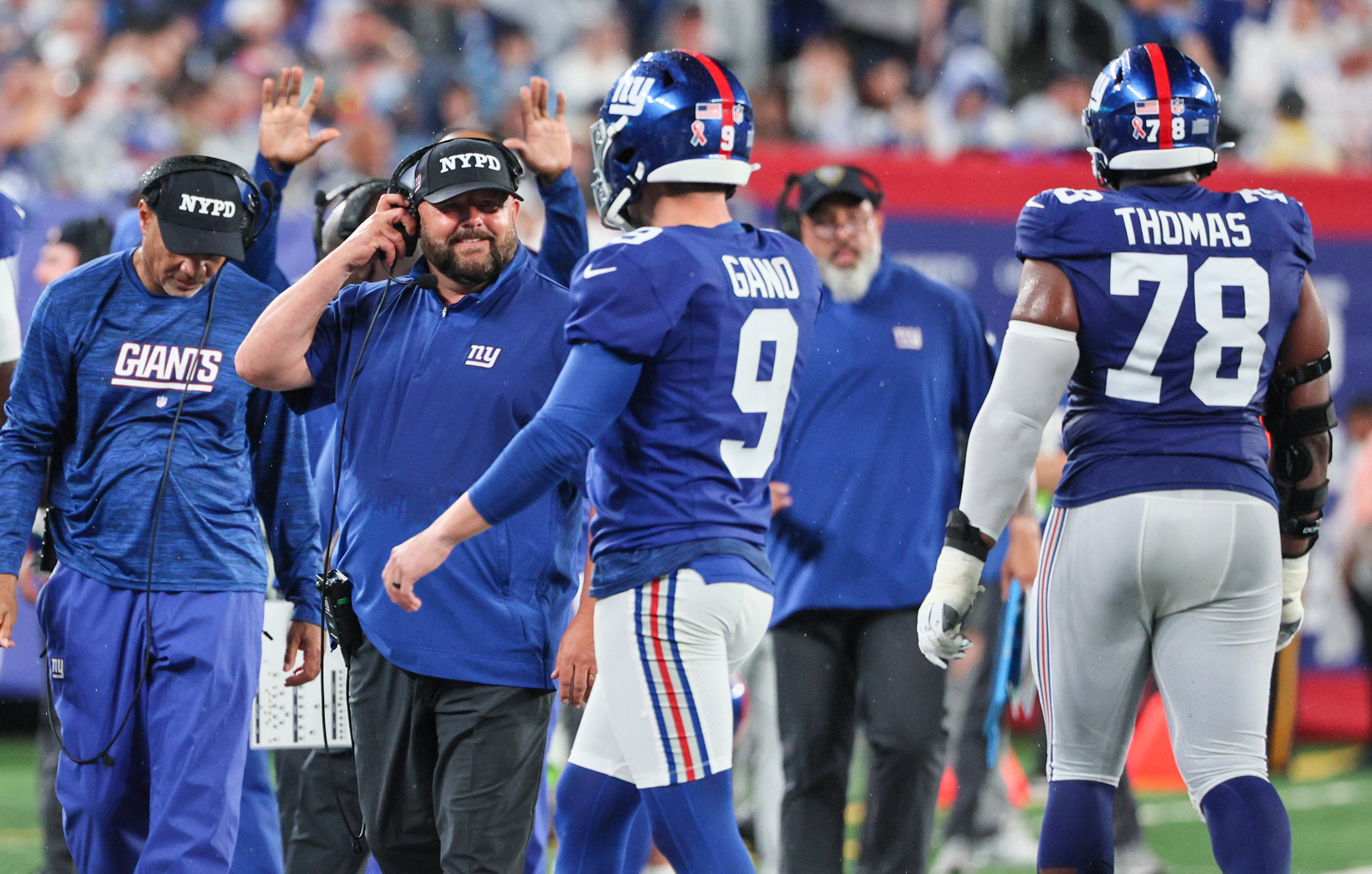 New York Giant Eli Manning wears a NYPD hat on the sidelines. The