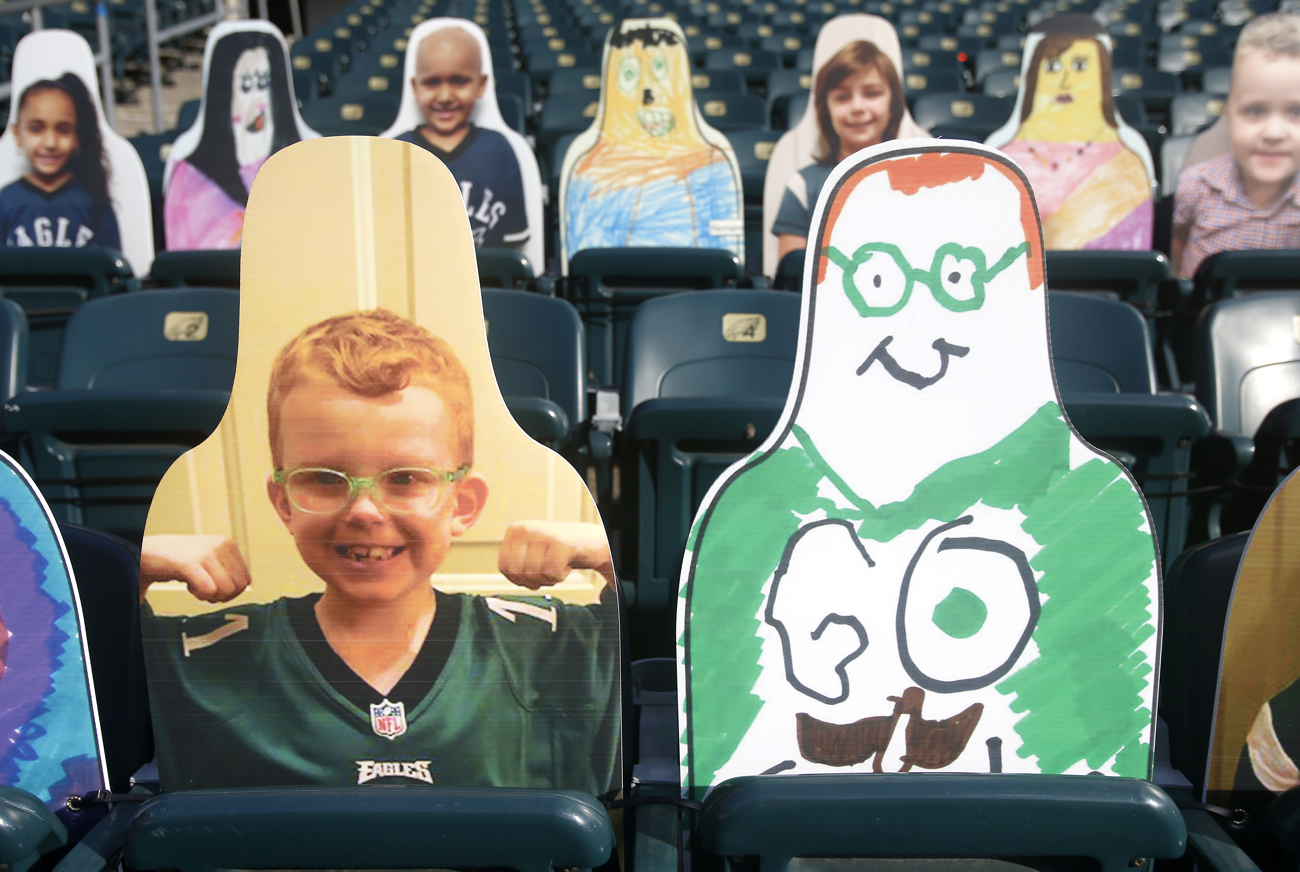 Cardboard cutouts of kids and their selfportraits popping up in stands