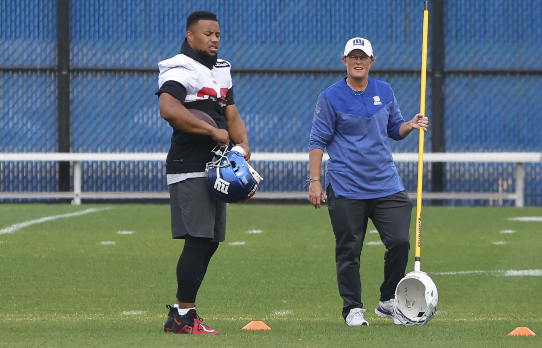 New York Giants running back Saquon Barkley (26) and assistant coach Laura Young during practice on Wednesday, Oct. 26, 2022. 