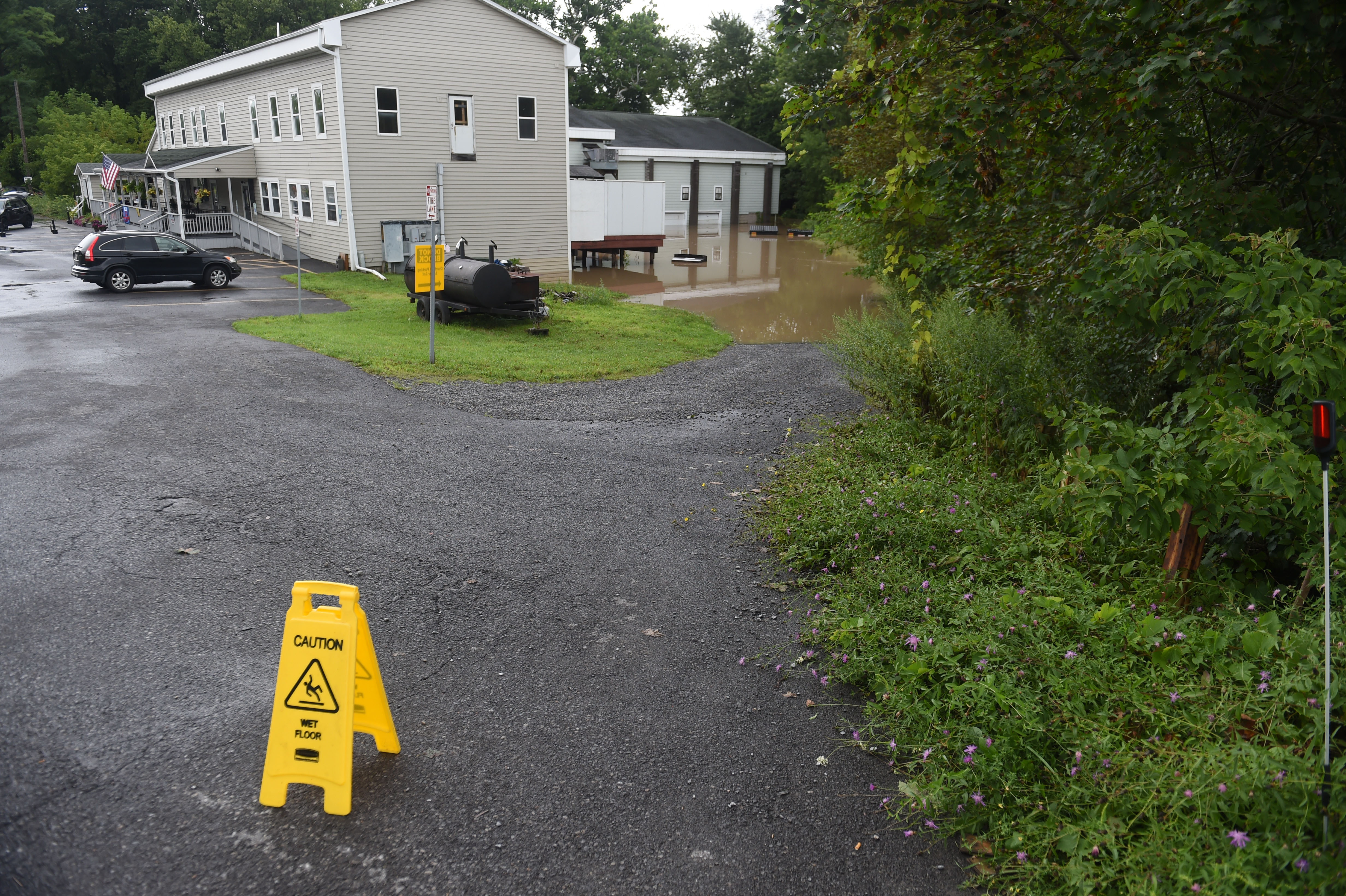 A sign at the TK Tavern where flooding overwhelmed the backyard August 19, 2021. Heavy rains again created flooding in Central New York with a lot of flooding occurring along Ninemile Creek in Camillus and Marcellus. Dennis Nett | dnett@syracuse.com
