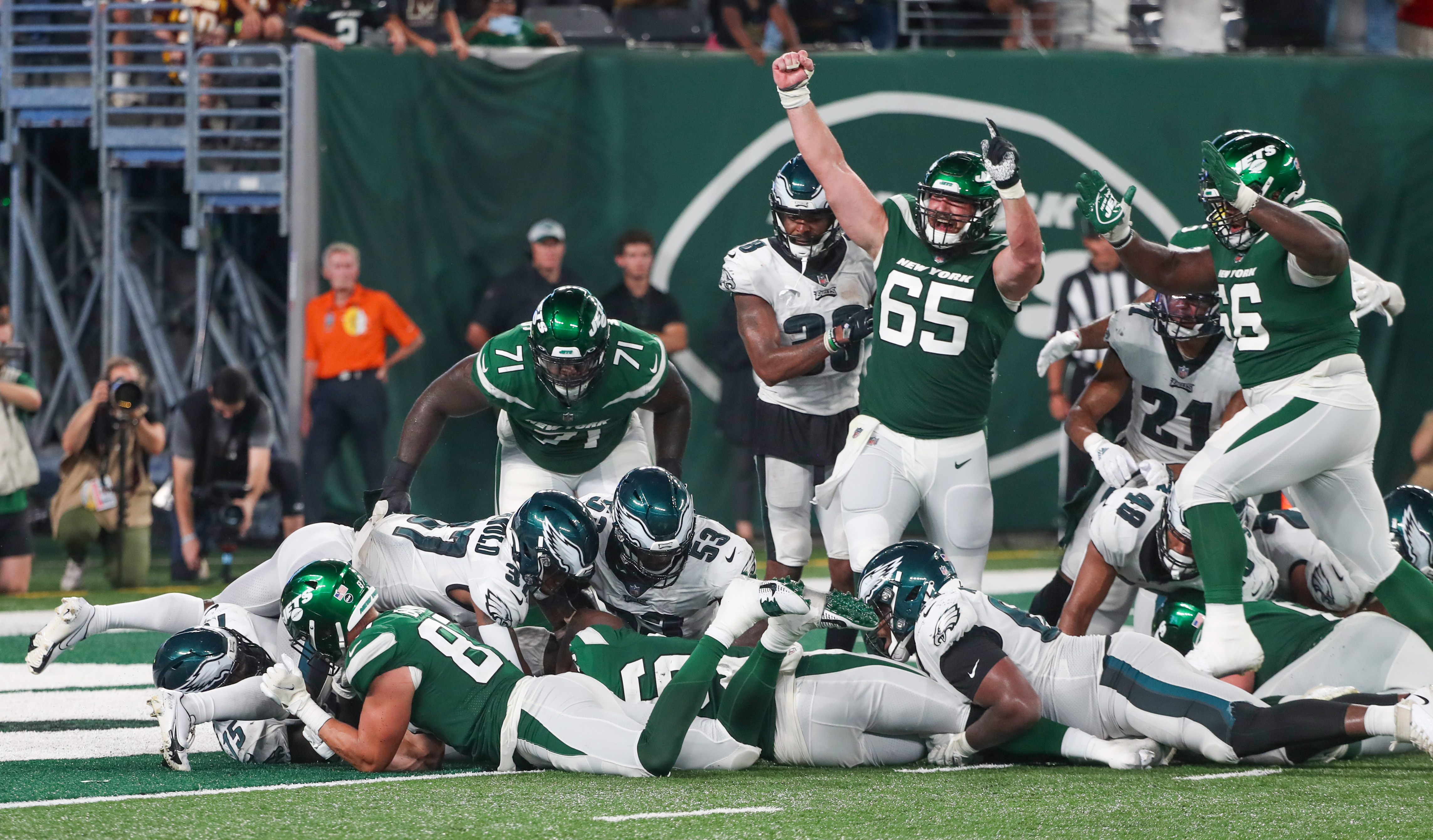 New York Jets quarterback James Morgan, below, is sacked by Philadelphia  Eagles' Matt Leo (64) and T.Y. McGill during the second half of an NFL  preseason football game Friday, Aug. 27, 2021