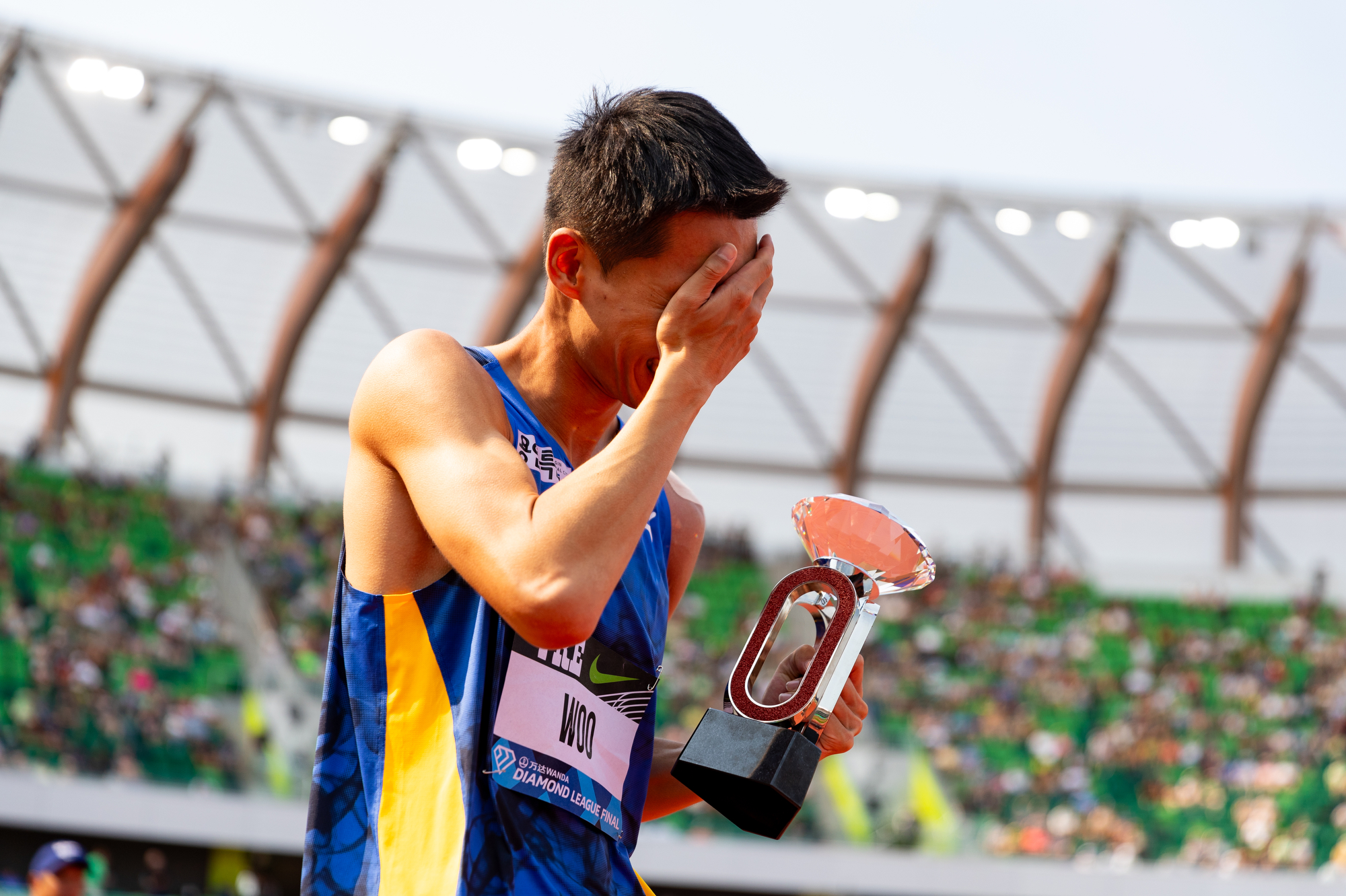 South Korea's Sanghyeok Woo celebrates with the Diamond League trophy after winning the men's high jump at the Prefontaine Classic track and field meet on Saturday, Sept. 16, 2023, at Hayward Field in Eugene.