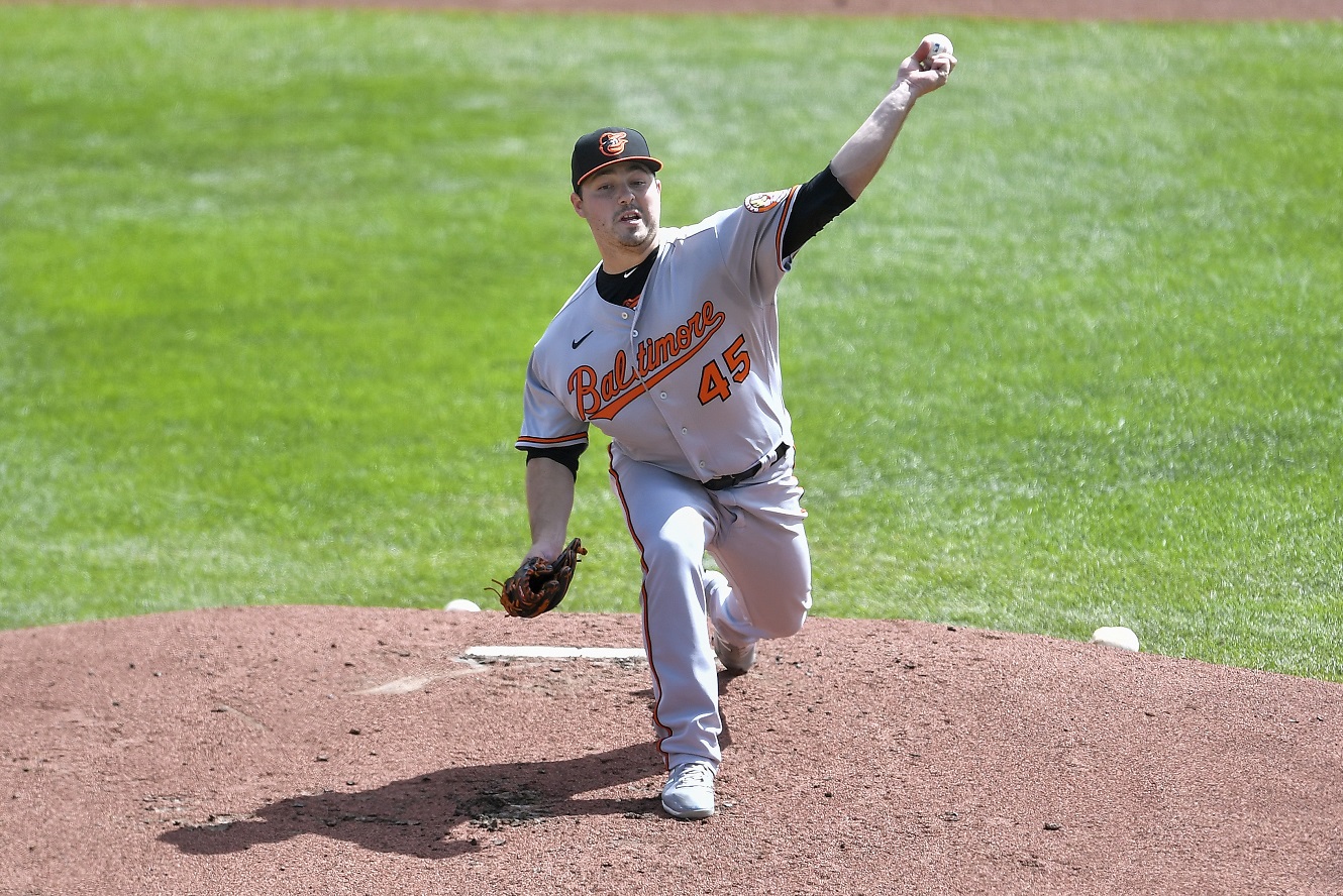 Pitcher Mychal Givens throws during the first day of workouts for