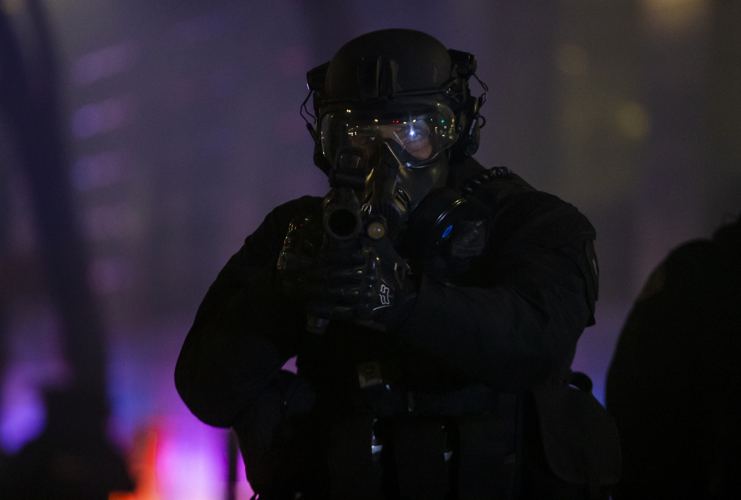 A police officer aims a weapon while dispersing the crowd after protesters took to the streets of Portland, Ore., for the 11th consecutive day of demonstrations on Sunday, June 7, 2020. The calls for change started after the May 25 death of George Floyd.  Dave Killen/Staff
