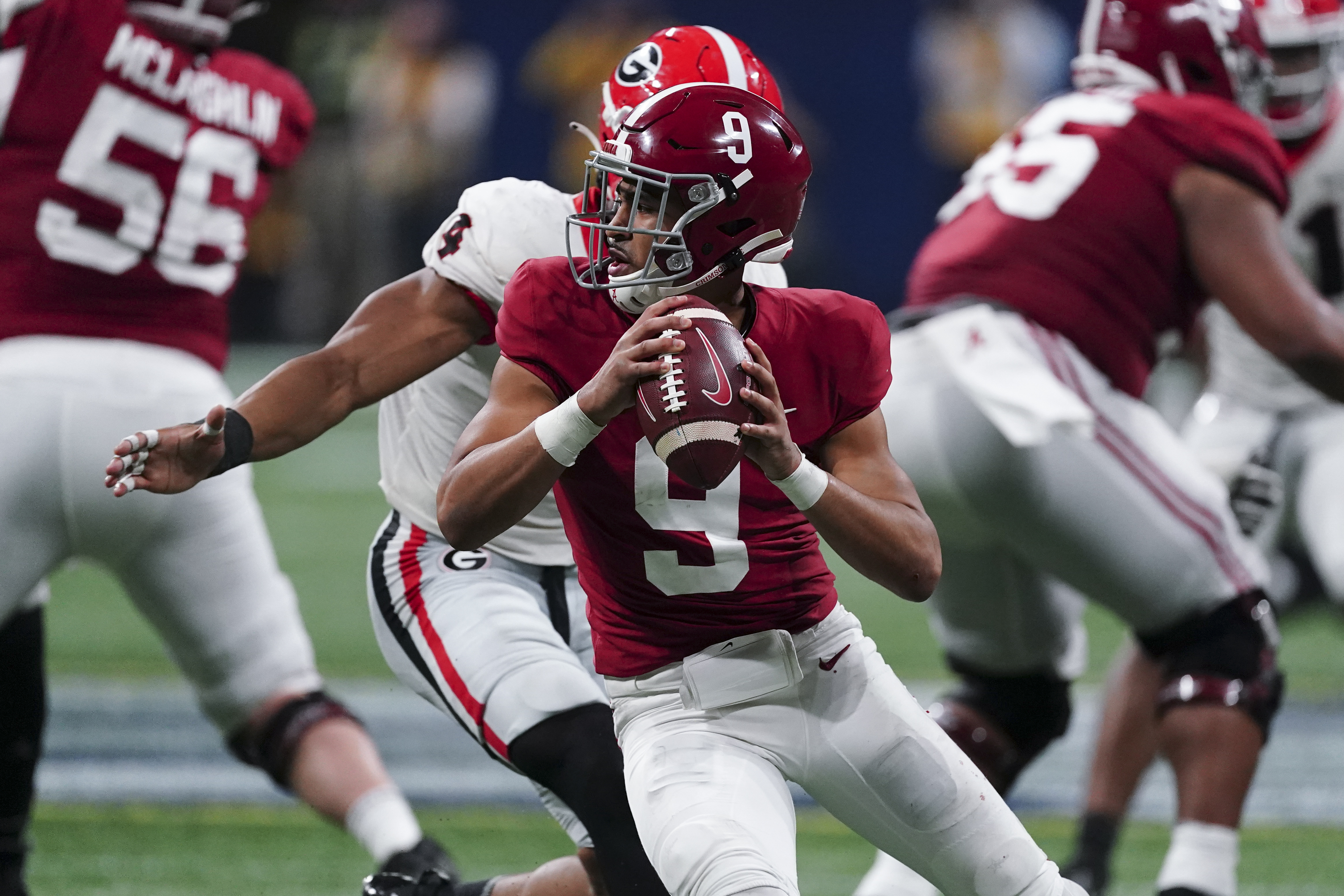 Bryce Young receiving help from Mac Jones as rookie