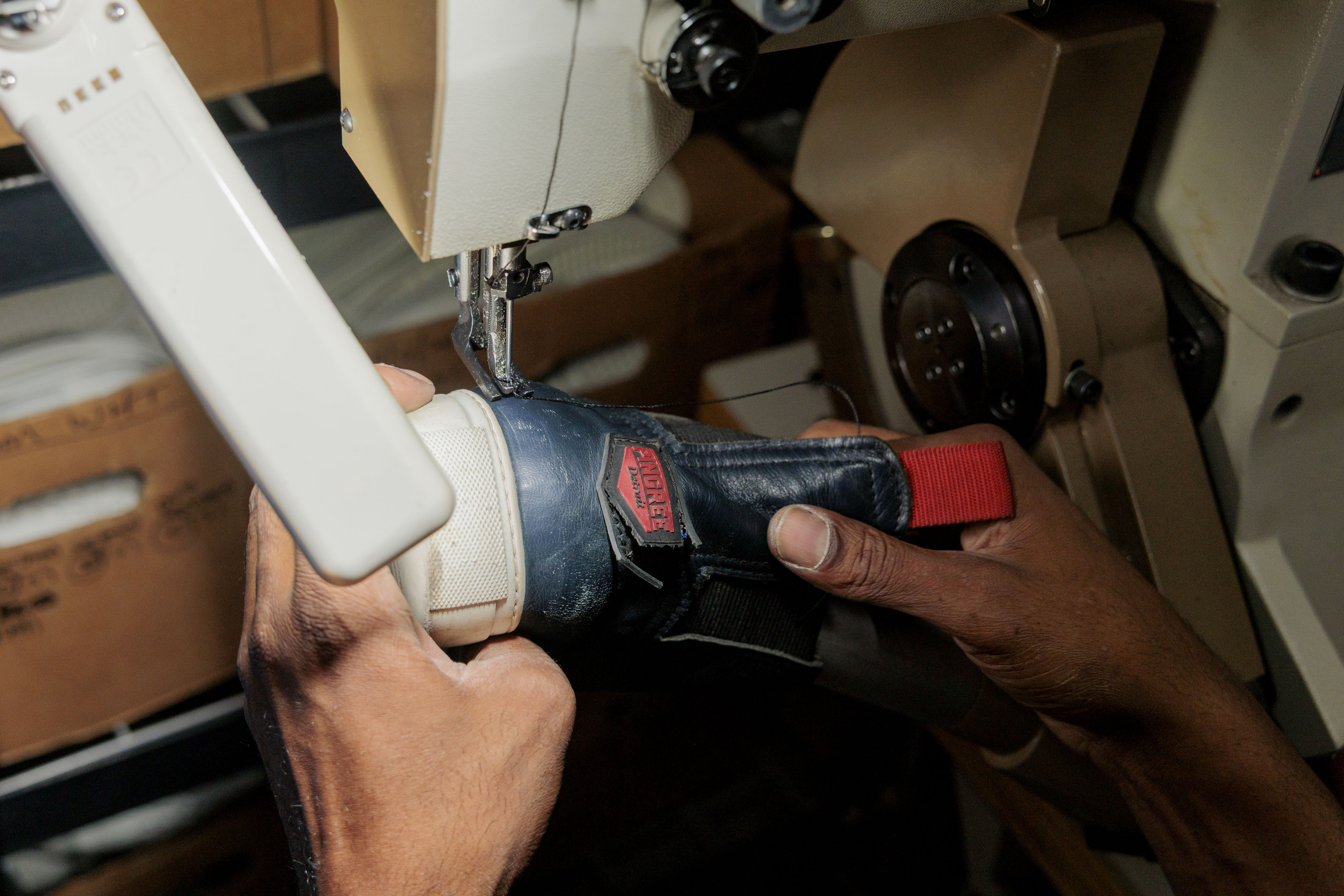 Nathaniel Crawford II, Co-Owner and Vice President of Footwear Operations, demonstrates stitching for custom hand-made shoes at Pingree Detroit, 15707 Livernois in Detroit on Monday, Oct. 6 2025.