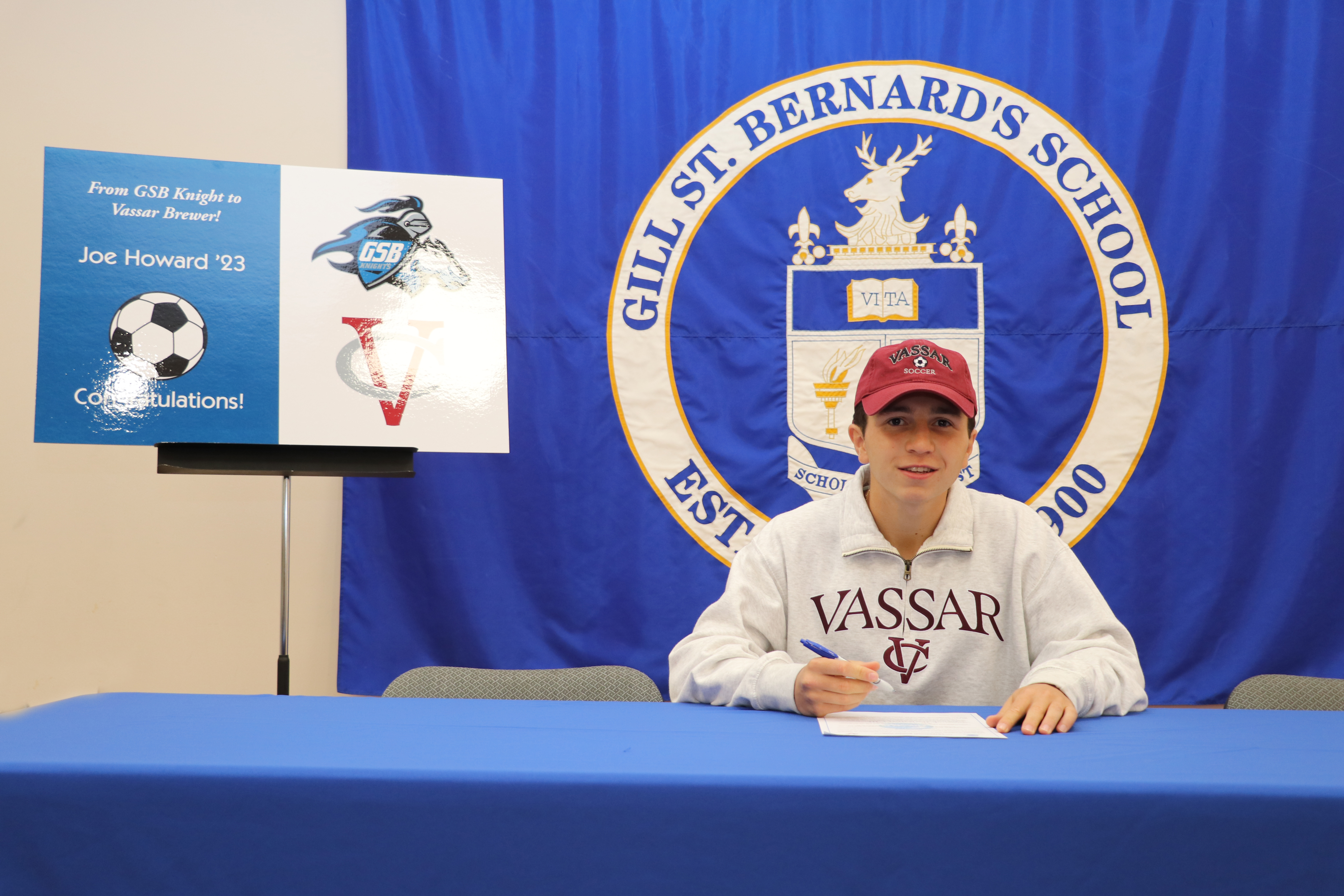 Joe Howard of Gill St. Bernard's signs a commitment letter to play soccer at Vassar College.