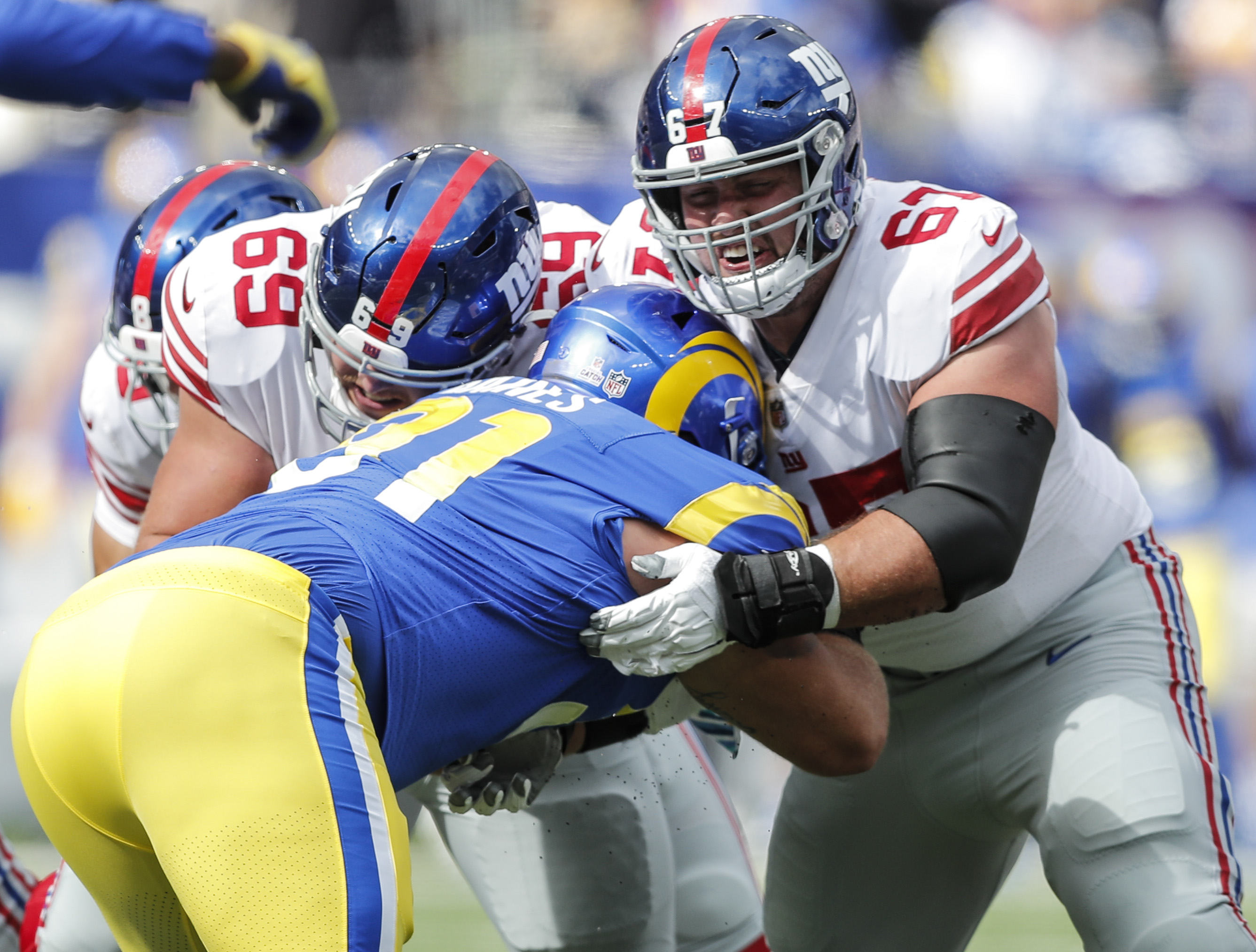 Los Angeles Rams defensive tackle Greg Gaines (91), right, tackles