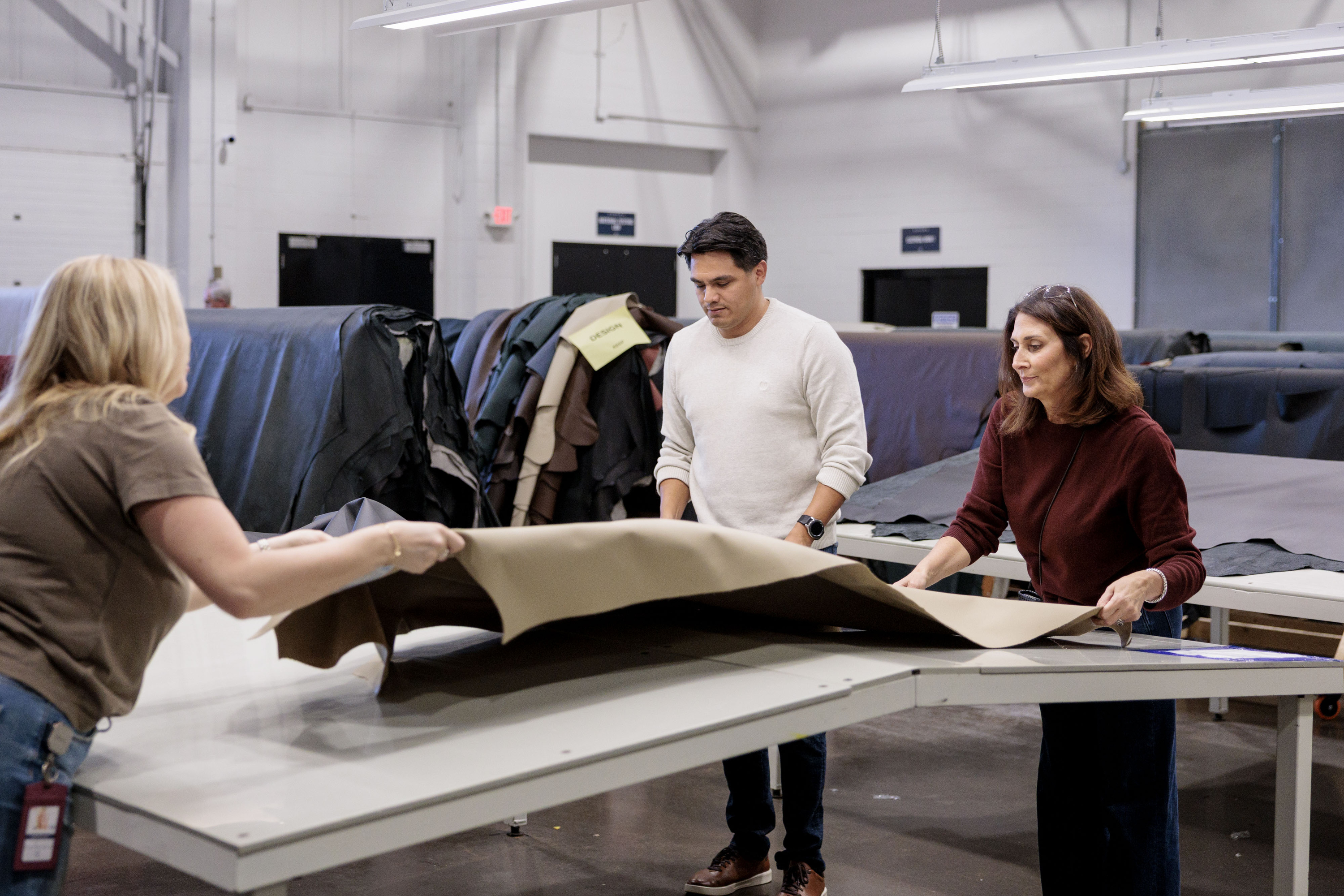 Catherine Ciftci, right, Senior Director of Global Design at Pangea, helps sort through automotive leather for donation with fellow Pangea employees at the company’s offices in Rochester Hills on Monday, Oct. 6 2025.