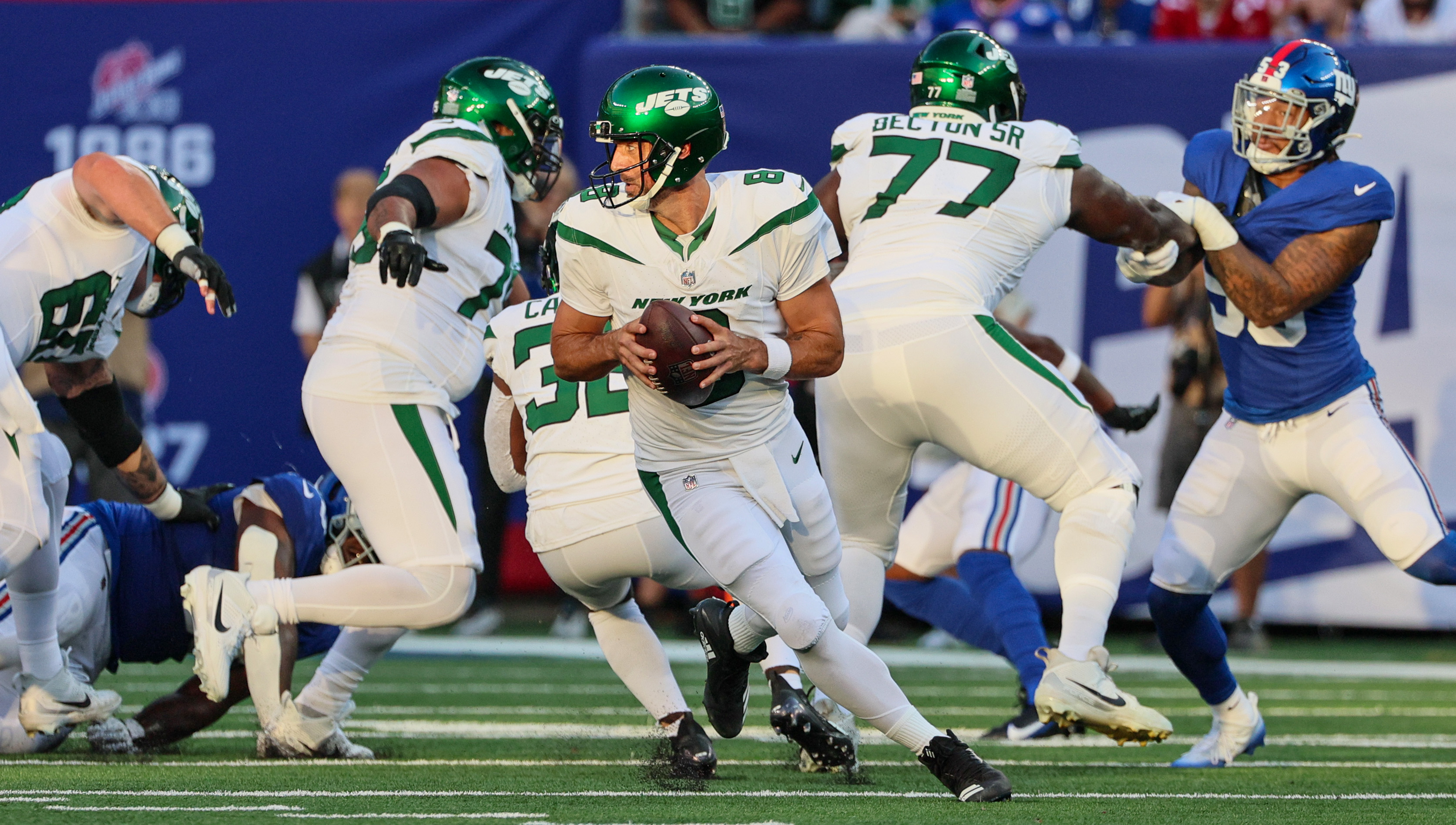 New York Jets quarterback Aaron Rodgers (8) runs off the field during  halftime of an NFL preseason football game against the New York Giants,  Saturday, Aug. 26, 2023, in East Rutherford, N.J. (