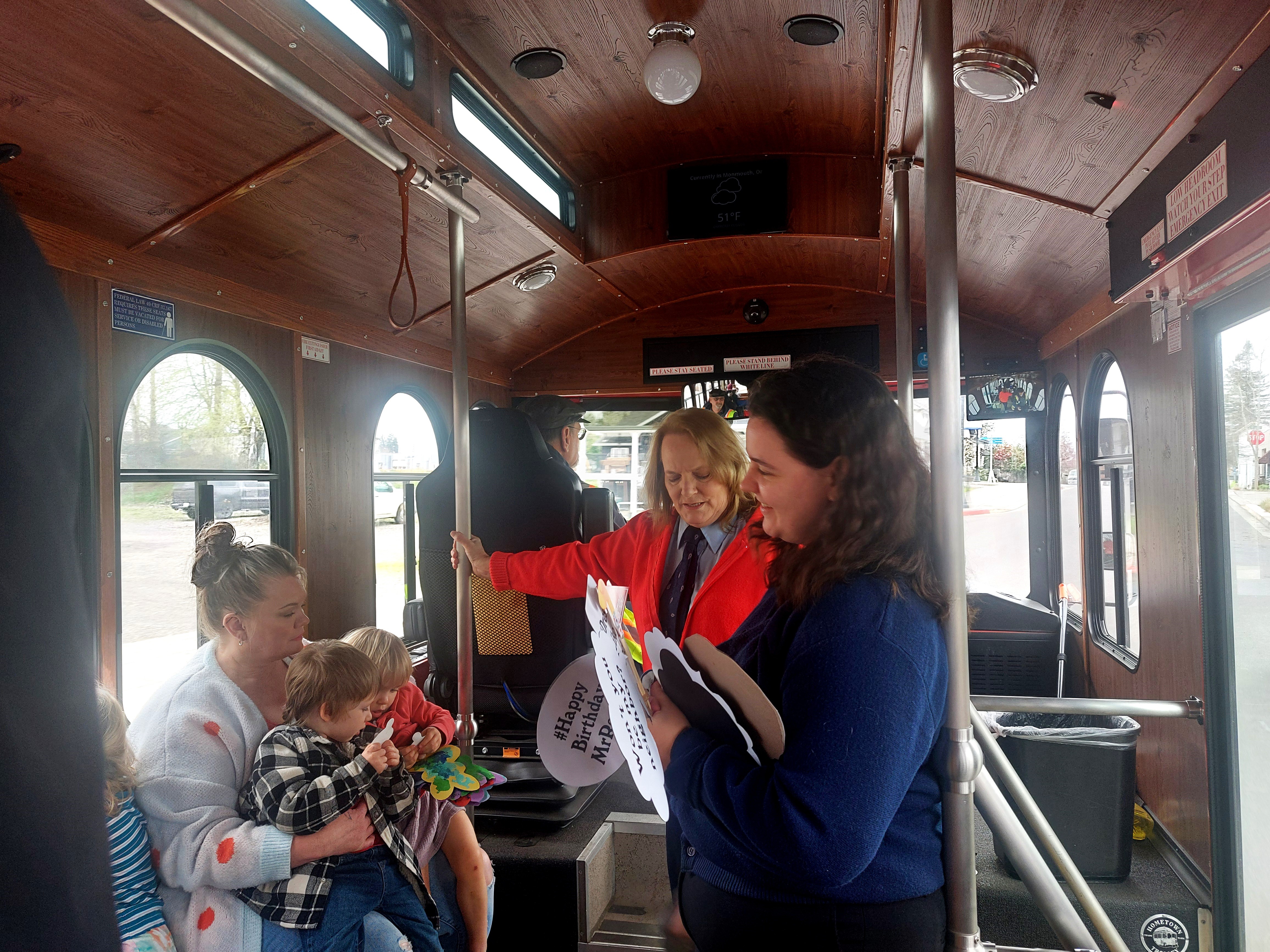 Roxanne Beltz and Laura Scully chat with riders inside the trolley