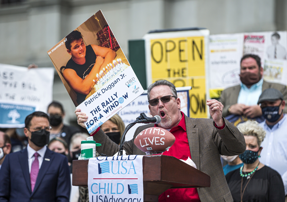 Patrick Duggan, a victim of child sexual abuse, speaks while holding a photo of his son who died two years ago. Victims of child sex crimes gather at the steps of the Pennsylvania Capitol for a statute of limitations rally to draw attention to the need to reform the statute, April 19, 2021. Dan Gleiter | dgleiter@pennlive.com