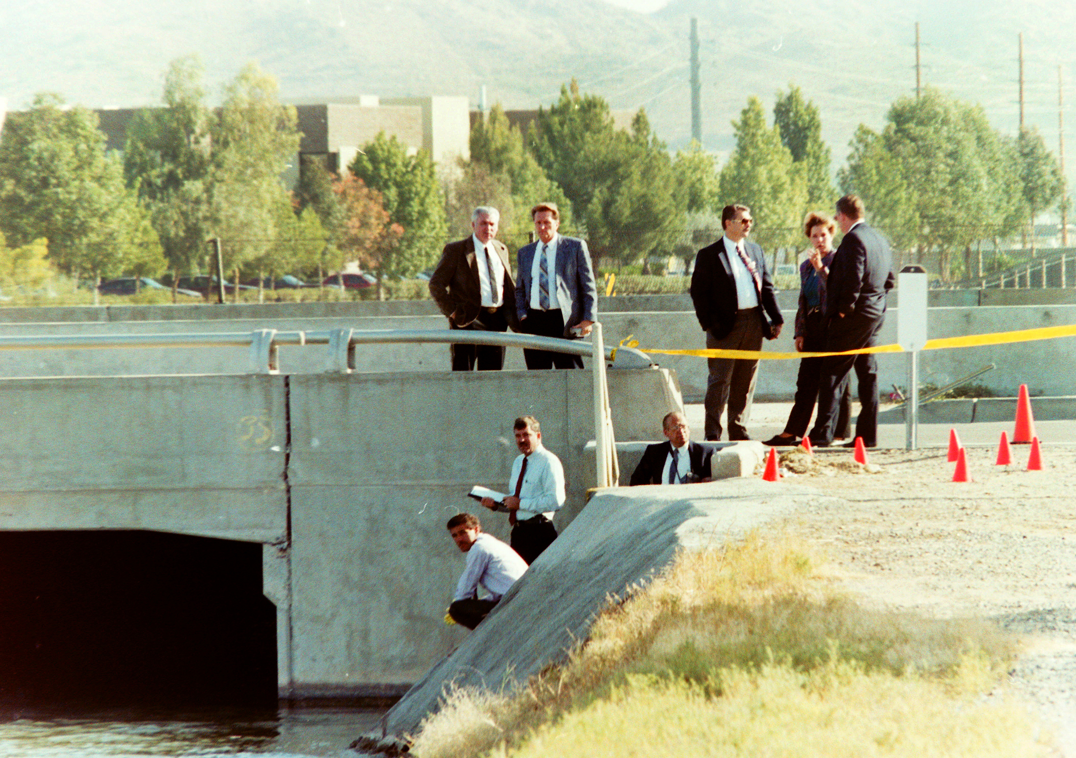 Phoenix police wait for officials from the Maricopa County Medical Examiner's office before removing a human head from the Arizona Canal in Phoenix, Ariz., on Nov. 20, 1992.  The head turned out to be Angela Brosso.  The Arizona Republic File Photo The Arizona Republic  File