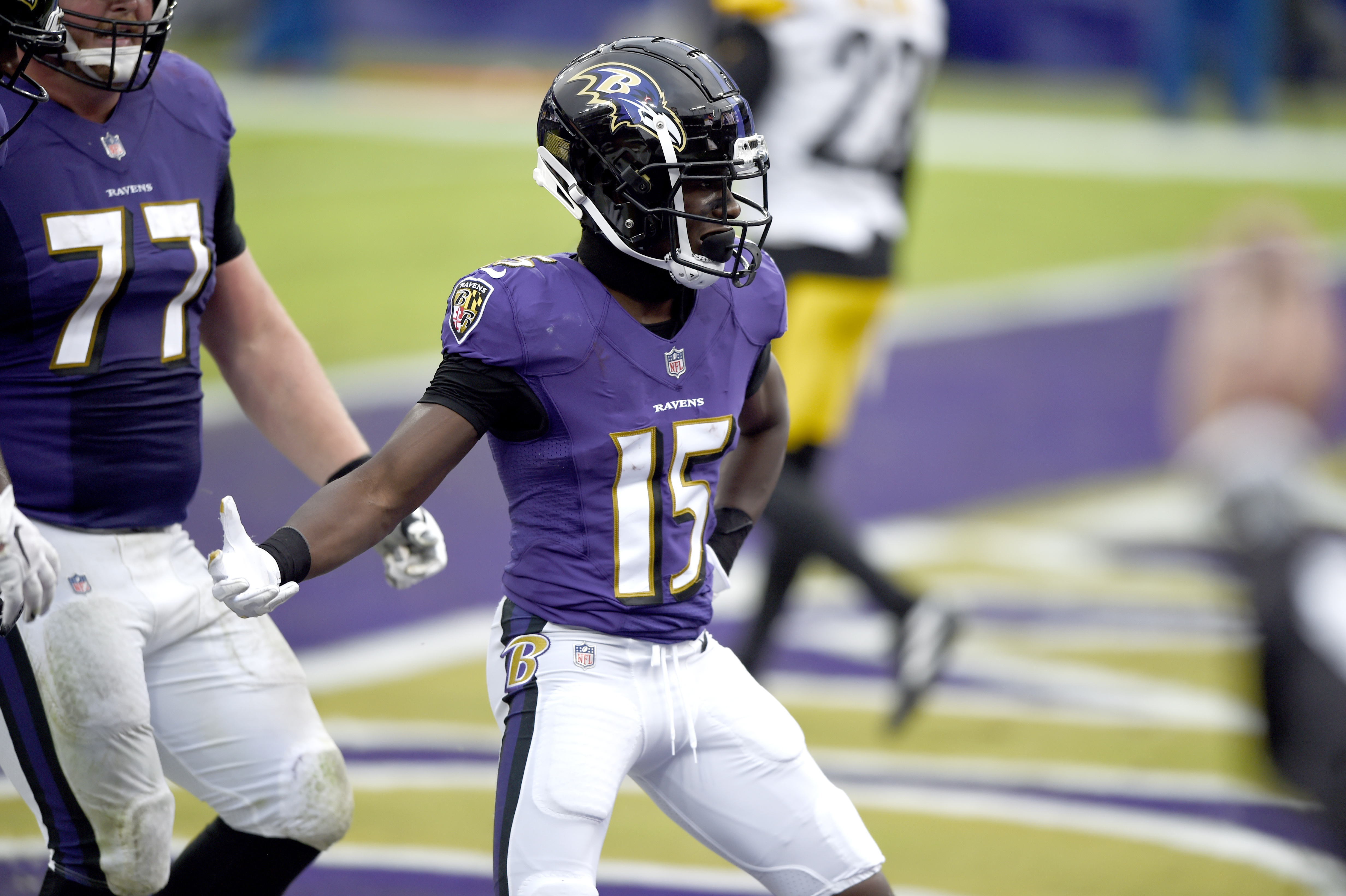 Baltimore Ravens quarterback Lamar Jackson, right, and Arizona Cardinals  wide receiver Marquise Brown, left, swap jerseys after an NFL preseason  football game, Sunday, Aug. 21, 2022, in Glendale, Ariz. The Ravens defeated