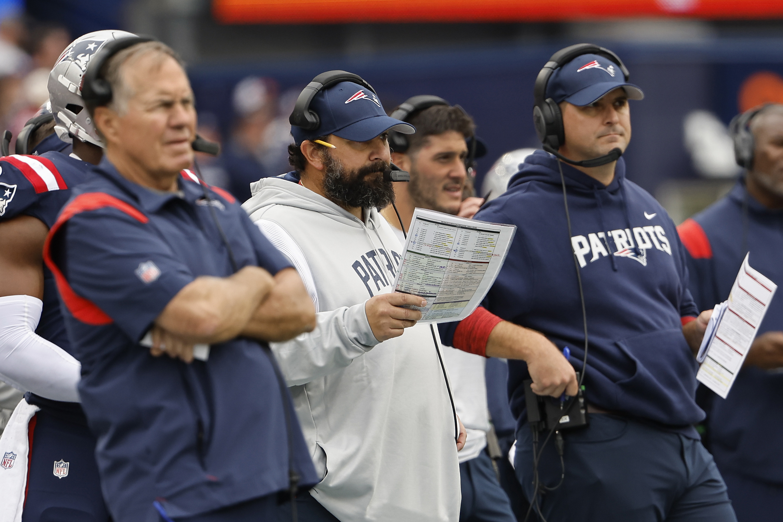 New England Patriots assistant coach Matt Patricia makes a play call on the  sideline while wearing in Italian flag on his shirt during the first half  of an NFL football game against