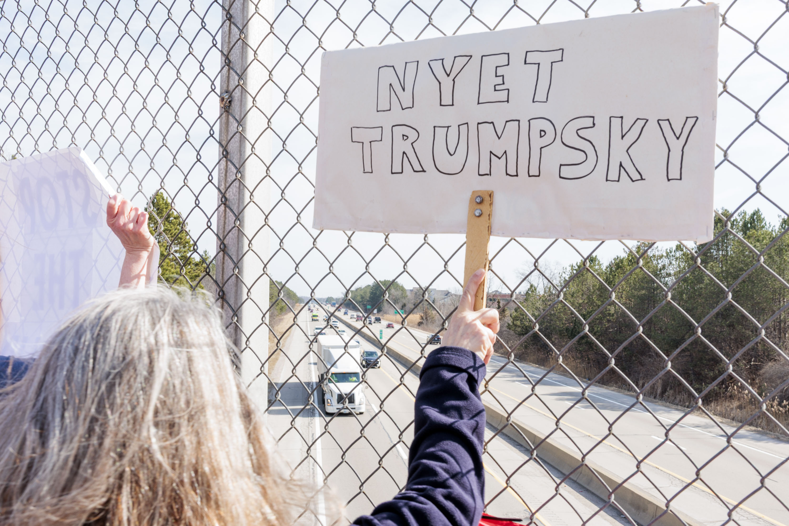 Demonstrators protest Trump Administration on four Ann Arbor pedestrian ...