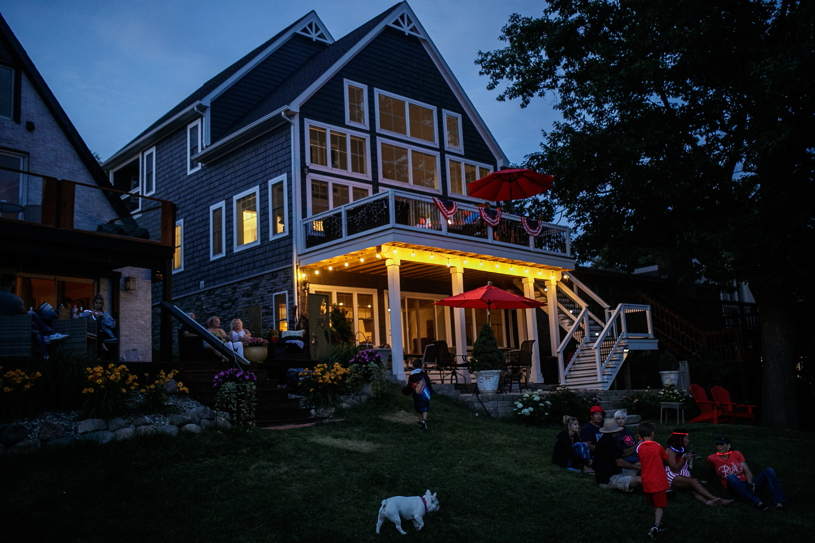 Families sit near the shore line in anticipation of the annual Lake Fenton Fireworks on the water in front of the Township hall on Saturday, June 2, 2022 in Fenton Township. (Jenifer Veloso | MLive.com)
