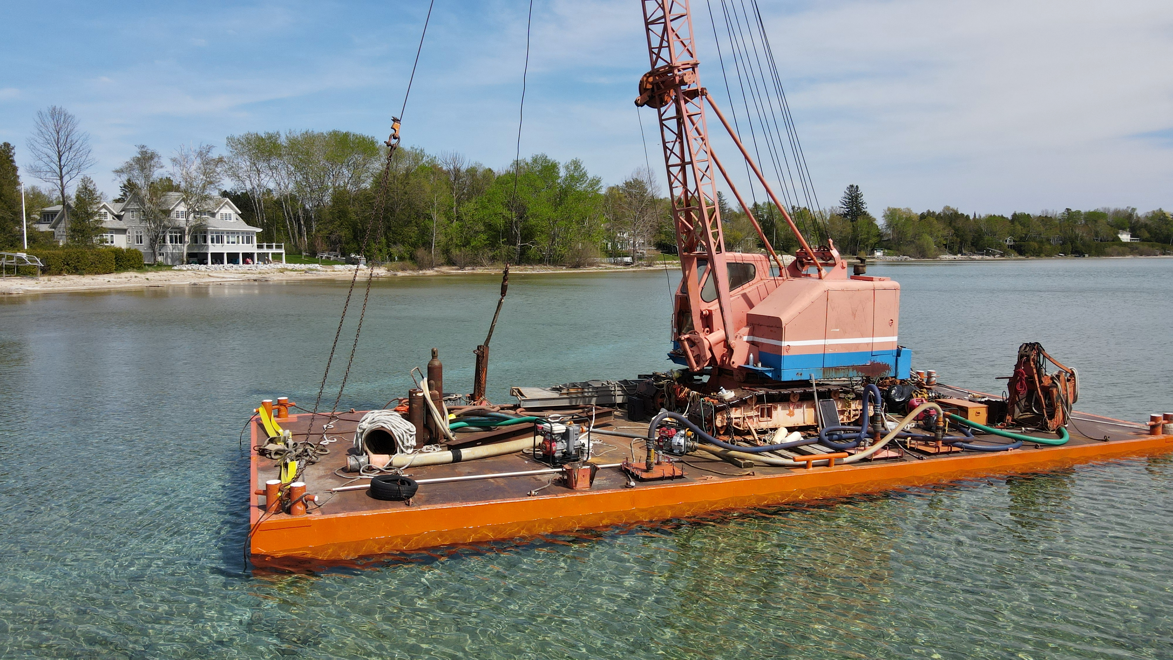A Balcom Marine Contracting barge in West Grand Traverse Bay’s Hall Bay near Northport, Mich., May 13, 2023. The barge is notorious for sinking in various spots around the area. On June 22, Michigan Attorney General Dana Nessel charged owner Donald Balcom of Traverse City with a felony related to oil releases from the barge and other misdemeanors. (Garret Ellison | MLive) 