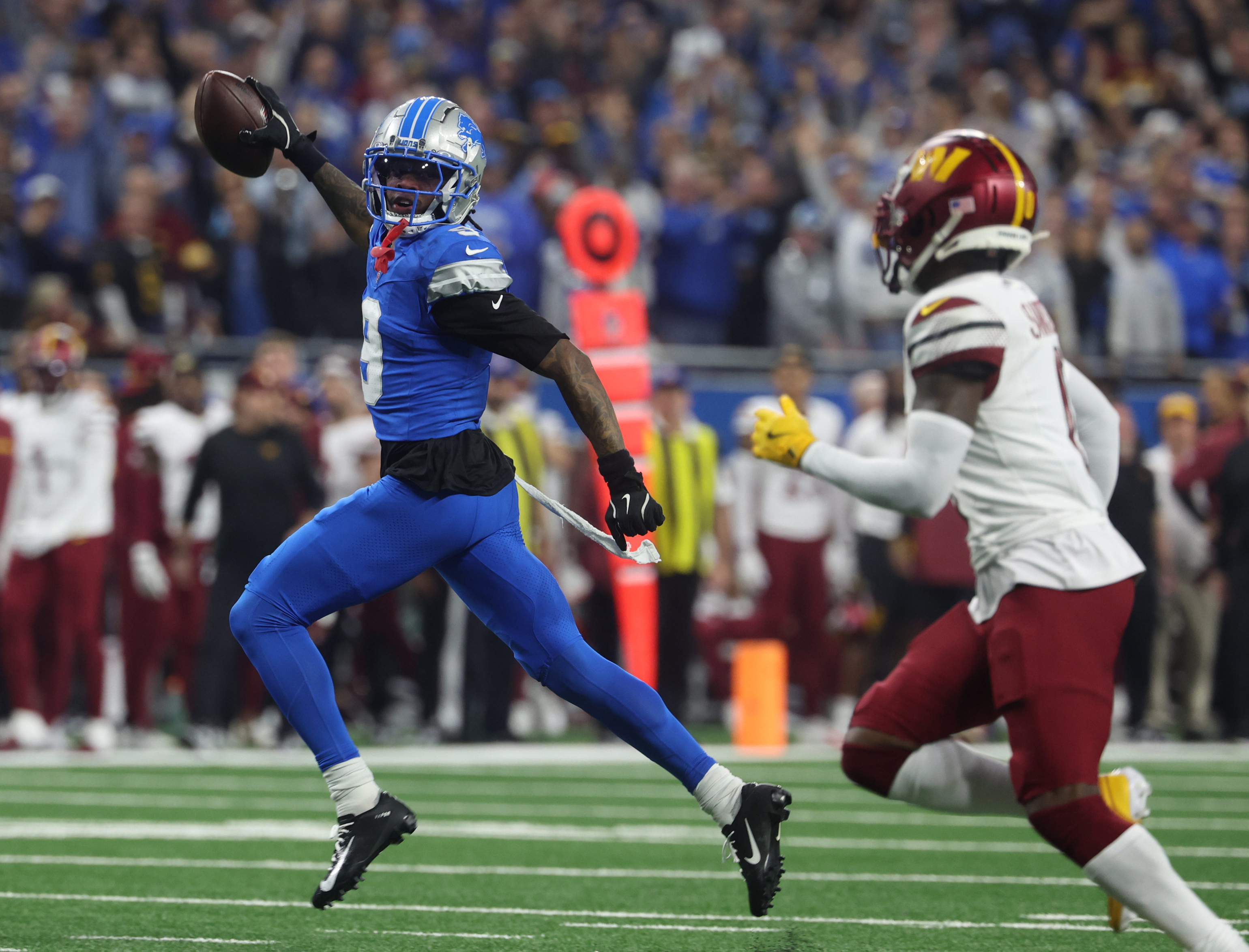 Detroit Lions wide receiver Jameson Williams (9) runs for a touchdown during the first half of an NFL football divisional playoff game, Saturday, Jan. 18, 2025, in Detroit. 