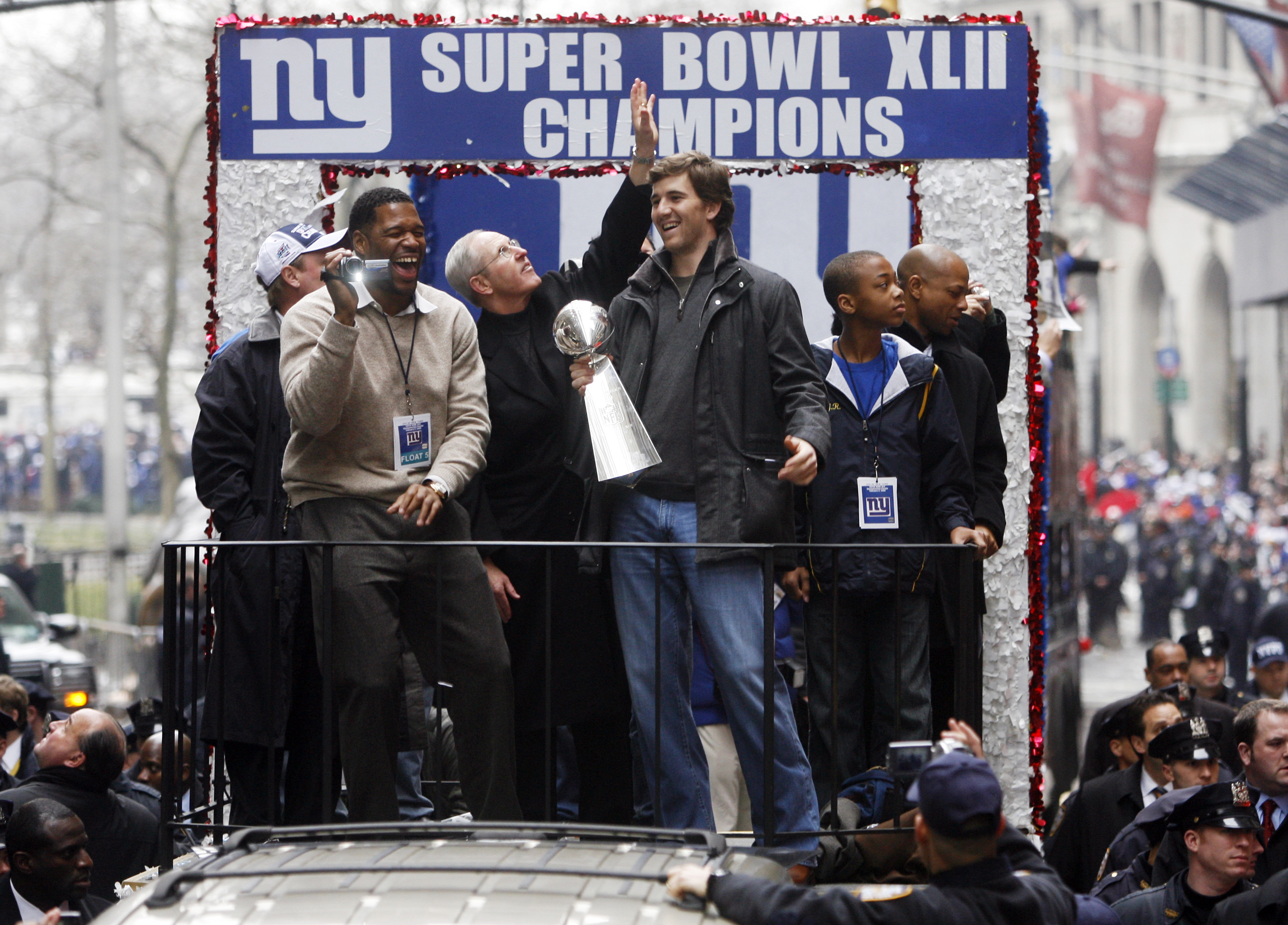 Michael Strahan (left) Coach Tom Coughlin, Eli Manning, Jerry Reese II and his father, Giants GM Jerry Reese celebrate with the Vince Lombardi Trophy as New York City celebrates the New York Giants win in Super Bowl XLII with a ticker tape parade up Broadway.  MANHATTAN, NYC (2008 file photo by Andrew Mills | The Star-Ledger)