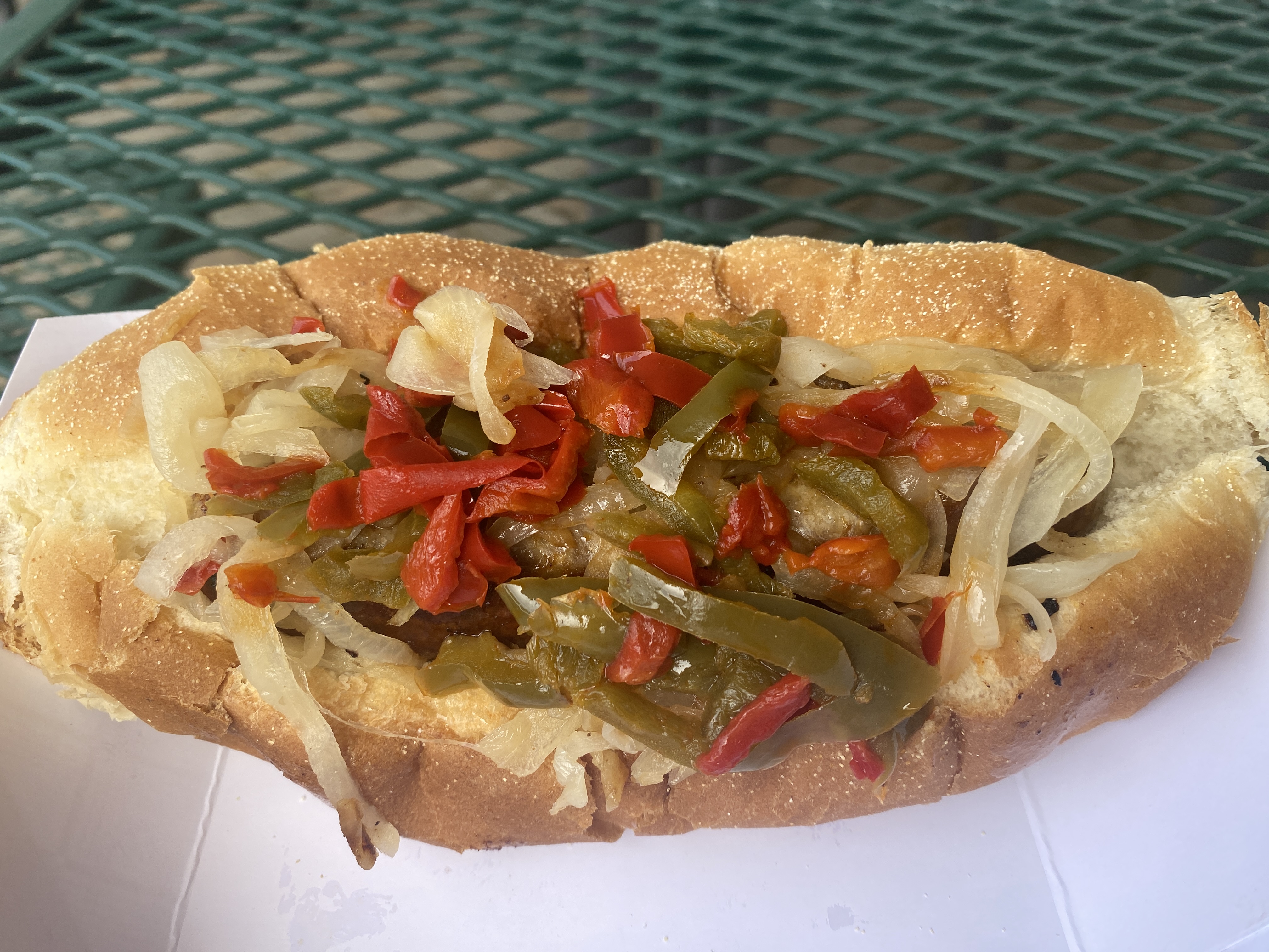 The sausage sandwich from PZO's is obscured by a heaping helping of peppers and onions on Wednesday, Aug. 23, 2023, on Restaurant Row at the New York State Fair. Samantha House | shouse@syracuse.com