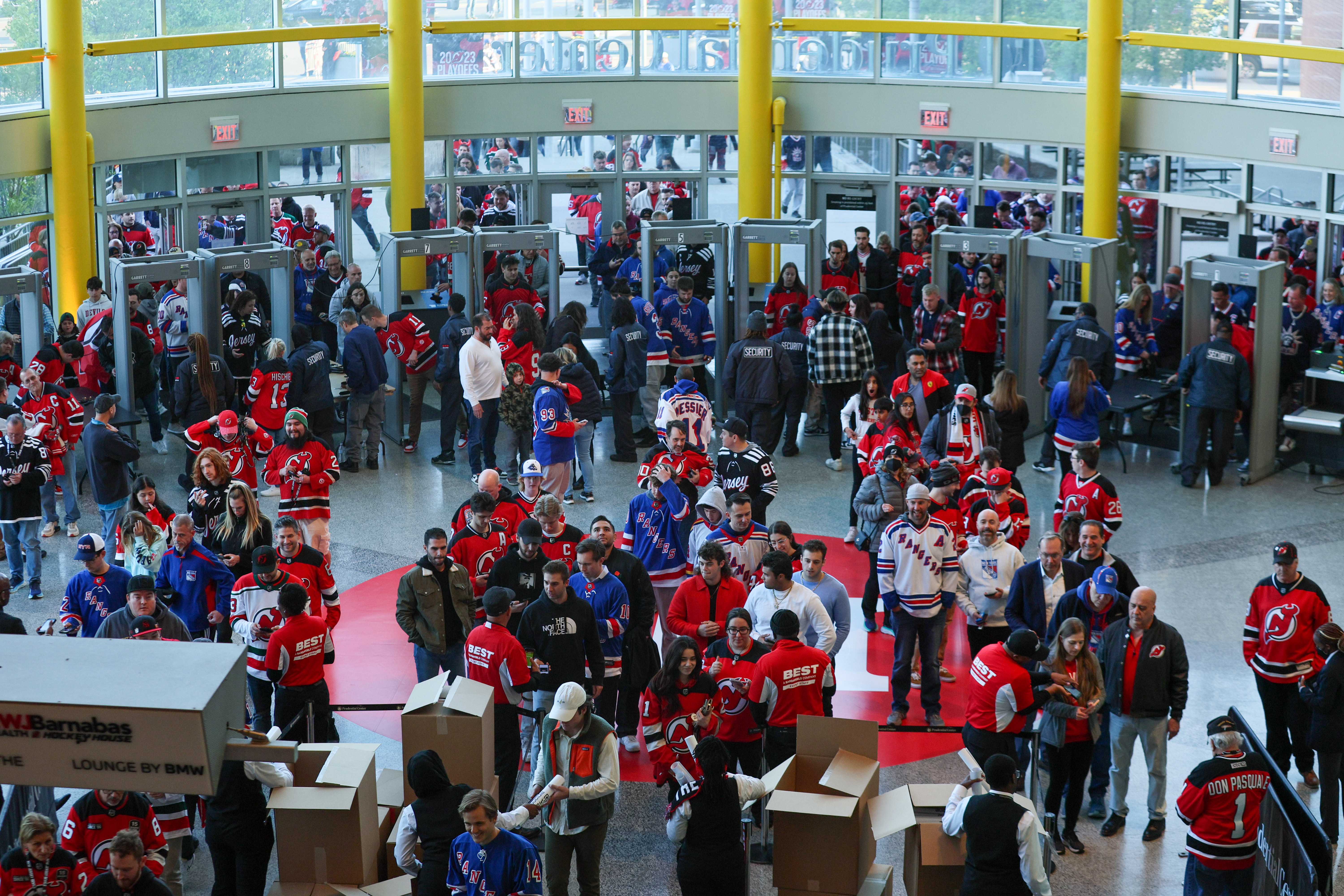 Fans pass through security metal detectors as they arrive at Prudential Center for Game 1 of the Stanley Cup playoffs series between the New Jersey Devils and the New York Rangers on Tuesday, April 18, 2023 in Newark, N.J. 