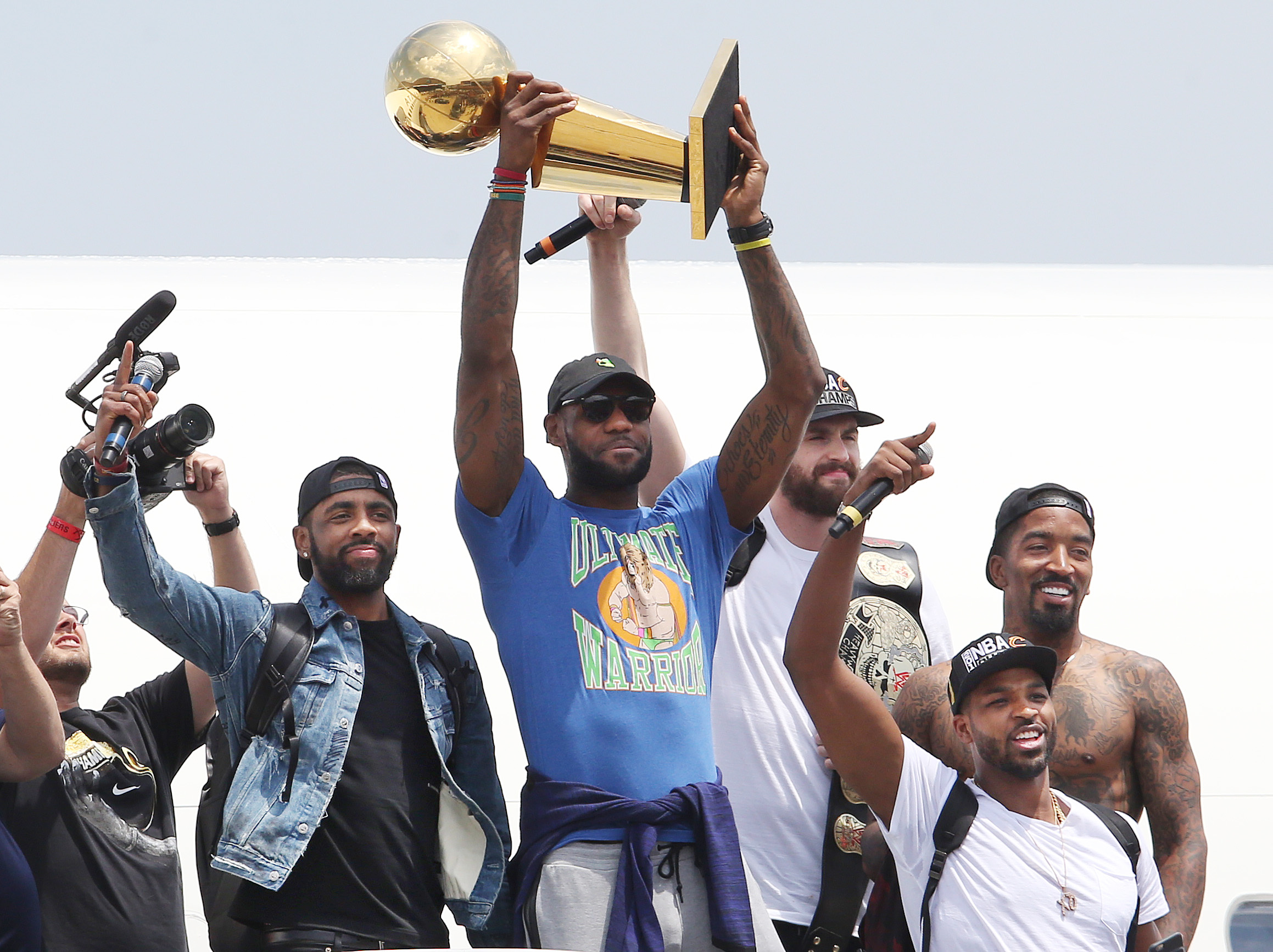 Cleveland Cavaliers' LeBron James holds up the championship trophy with teammates Kyrie Irving (L-R) Kevin Love, JR Smith and Tristan Thompson for the fans that packed the IX Center at Cleveland Hopkins Airport on the team's return home, June 20, 2016.    John Kuntz, cleveland.com 