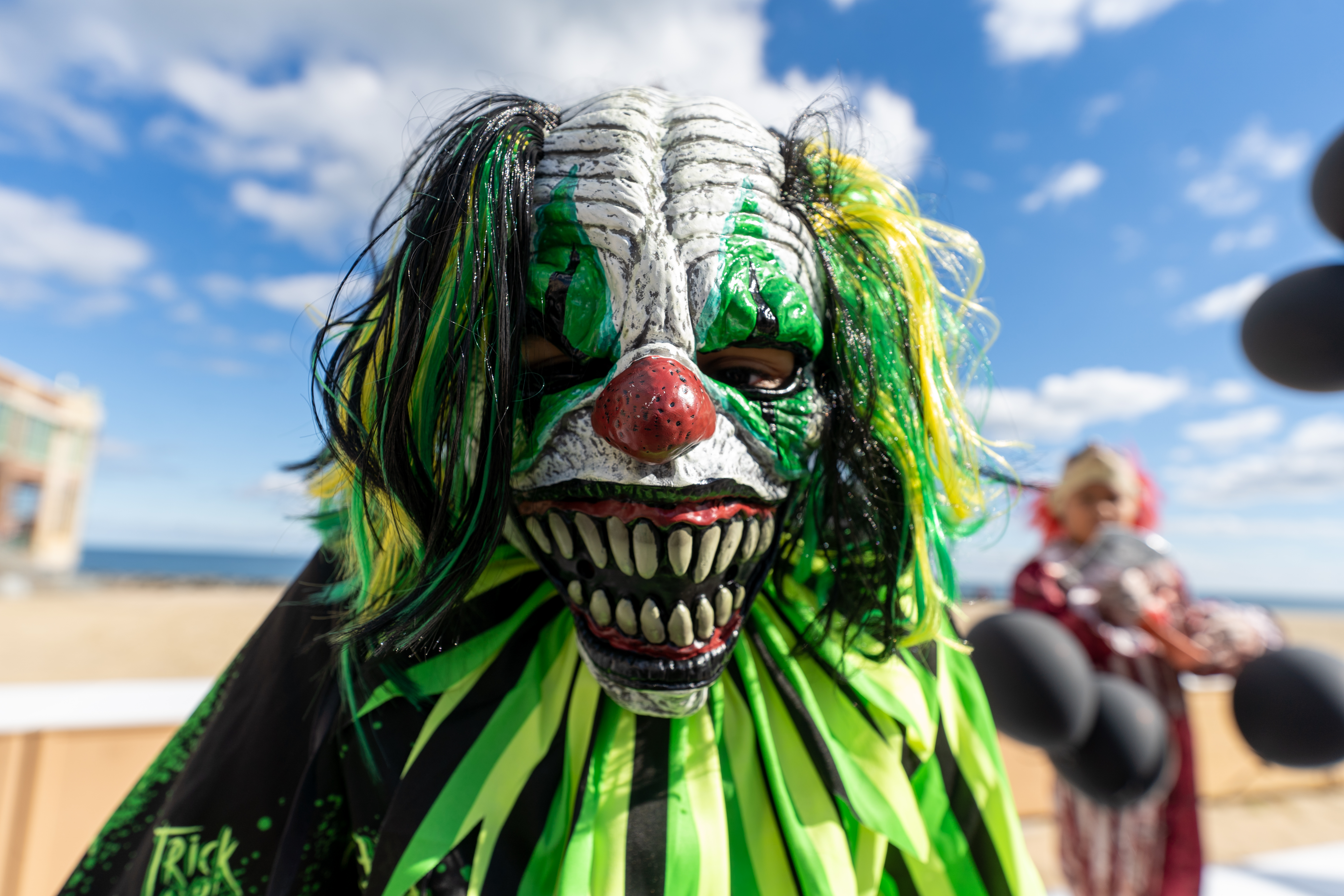 Neymar Pena, 9, dressed as a zombie clown, waits on the boardwalk for the zombie walk to begin during the 14th Asbury Park Zombie Walk in Asbury Park on Saturday, October 8, 2022. The zombie walk held its first themed year with the theme being 80's and 90's punk and metal.