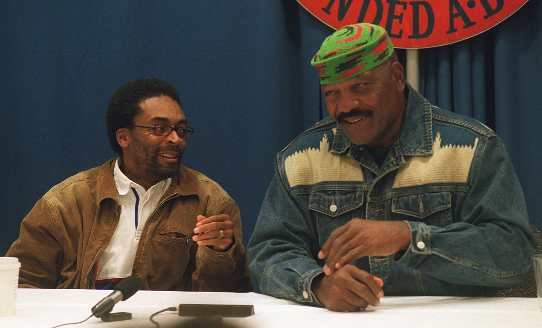 Filmmaker Spike Lee, left and football legend Jim Brown, right, chuckle during a press conference at Syracuse University in 2002 before the presentation of Lee's documentary of Brown's life entitled "JIm Brown; All-American." Brown played football and lacrosse at SU.
