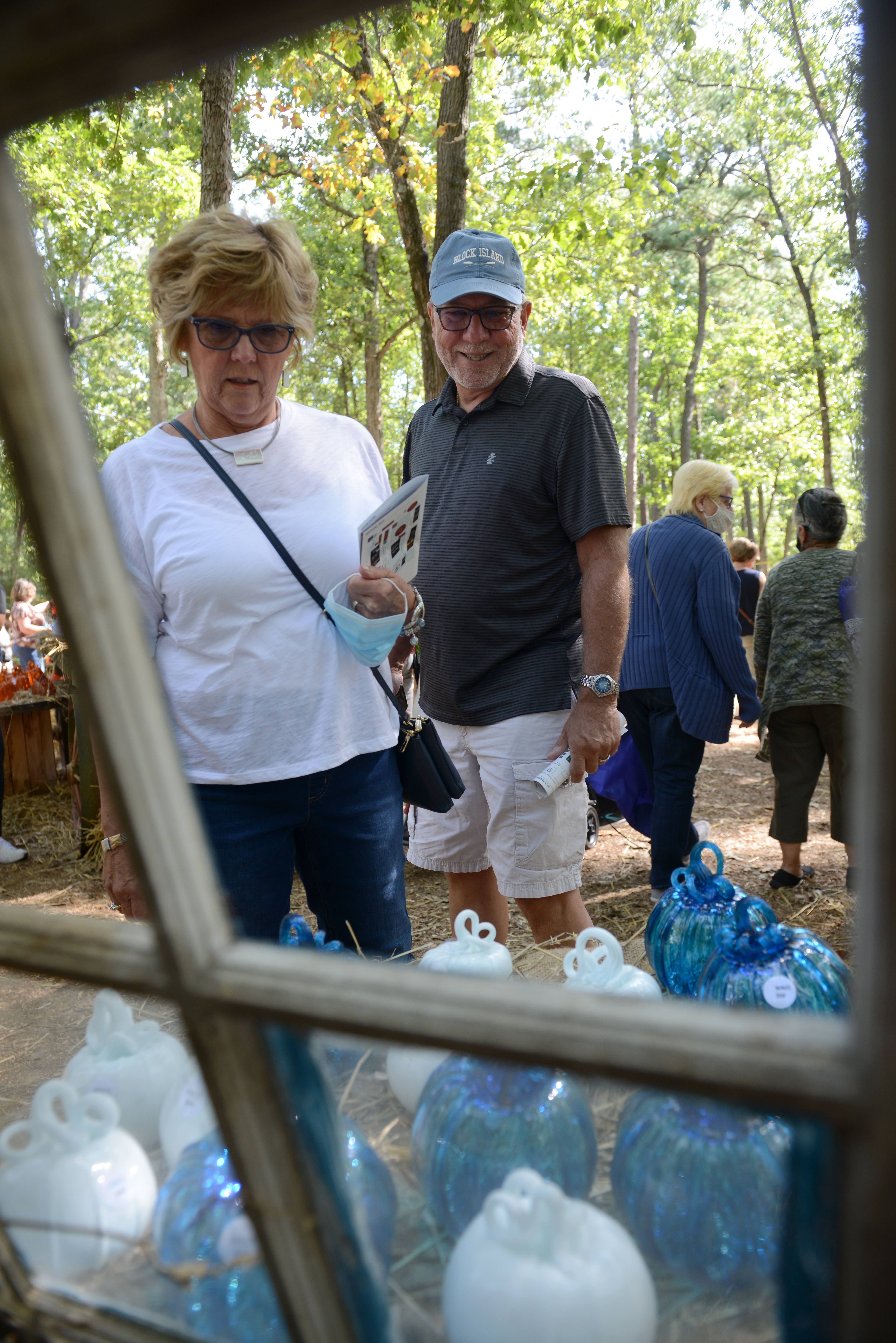 Customers browse the glass pumpkin patch during the 22nd annual Festival of Fine Craft at Wheaton Arts in Millville, Saturday, Oct. 2, 2021.