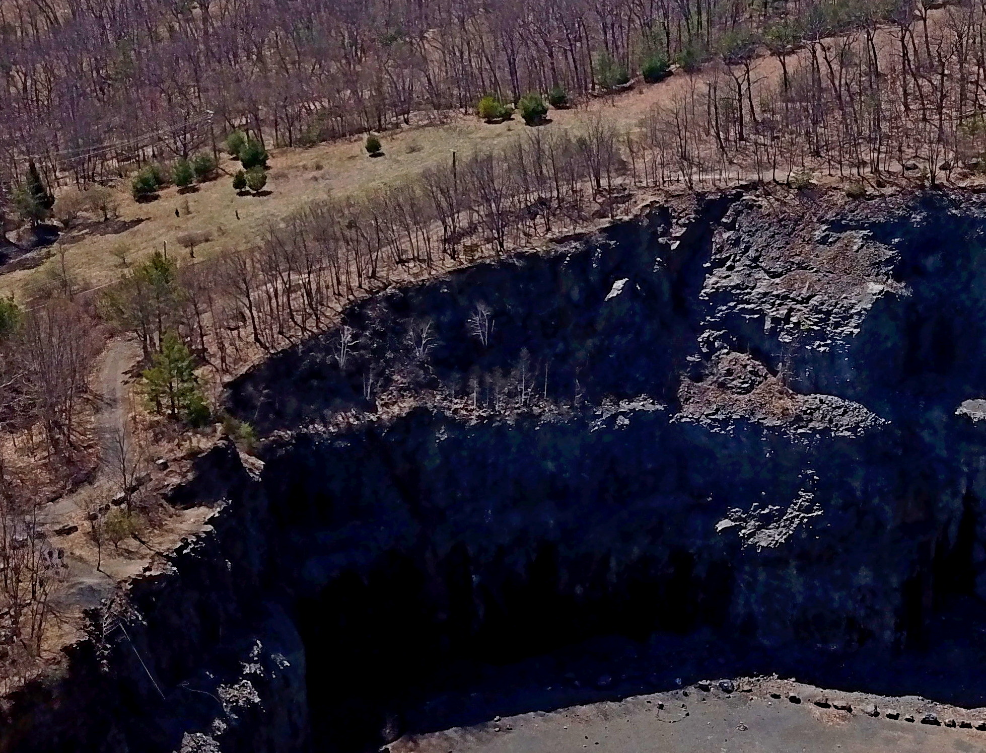 Aerial photo of the cliff face at the former Mt. Tom quarry. Note the hiking path that goes along the cliff. DCR officials want to install warning signs and an rope to prevent people from falling.