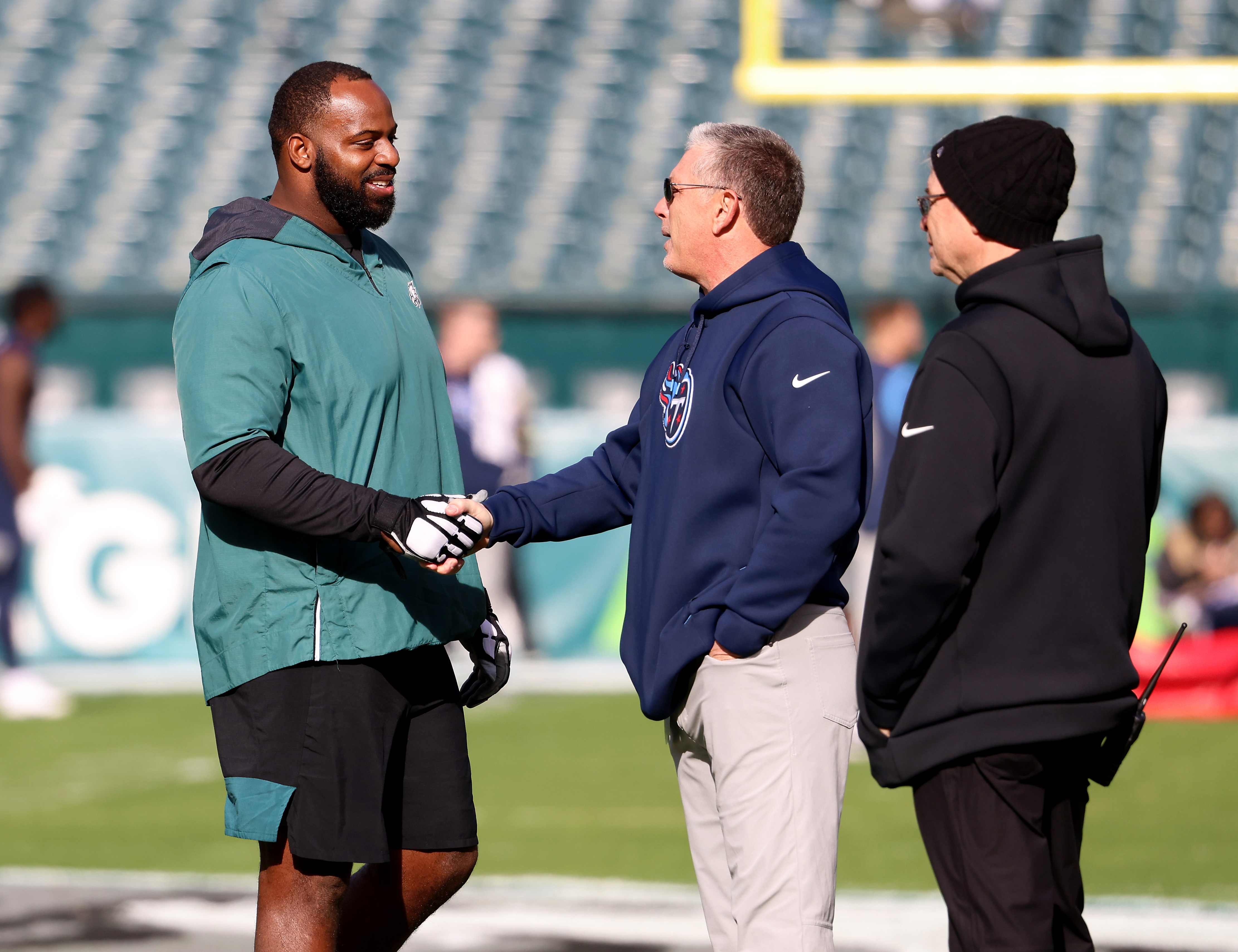 FILE - Green Bay Packers quarterback Aaron Rodgers talks with Tennessee  Titans senior advisor Jim Schwartz before an NFL football game Thursday, Nov.  17, 2022, in Green Bay, Wis. Schwartz is interviewing