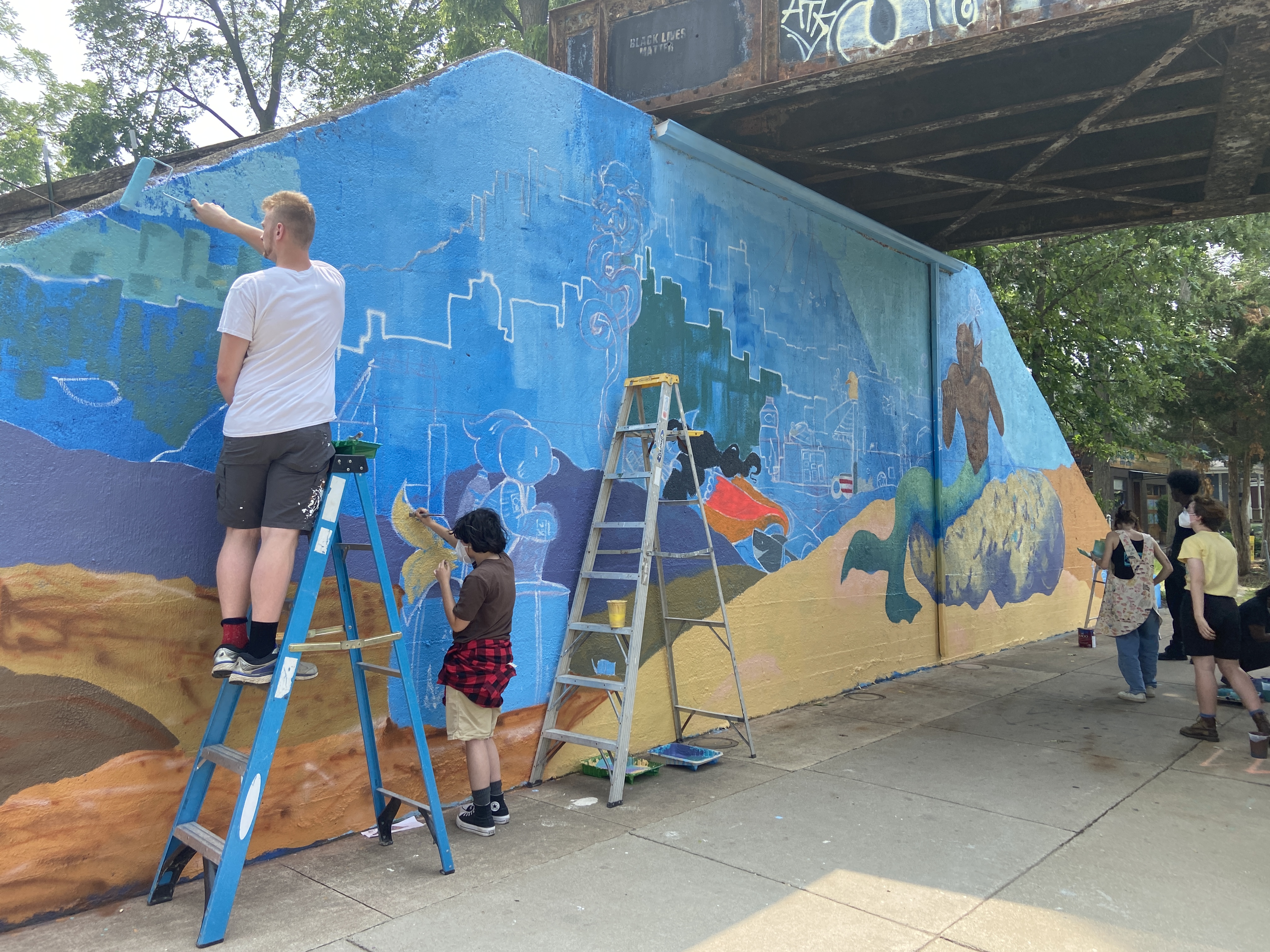 Young artists work to bring new murals to Miller Avenue's underpass ...