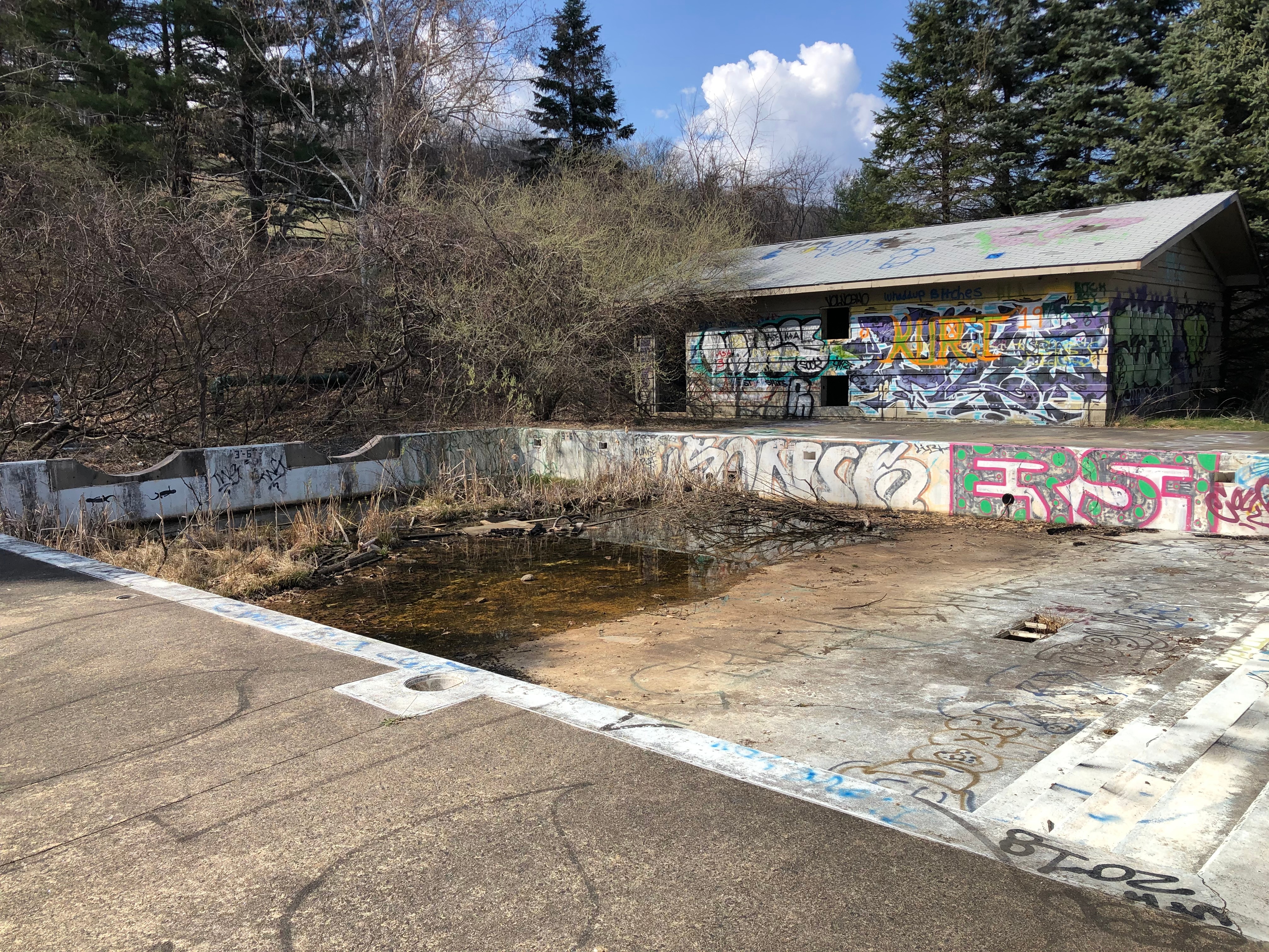 Site of the former Mt. Tom Ski Area's water slide. Abandoned for 22 years, it has standing water and is covered with graffiti.